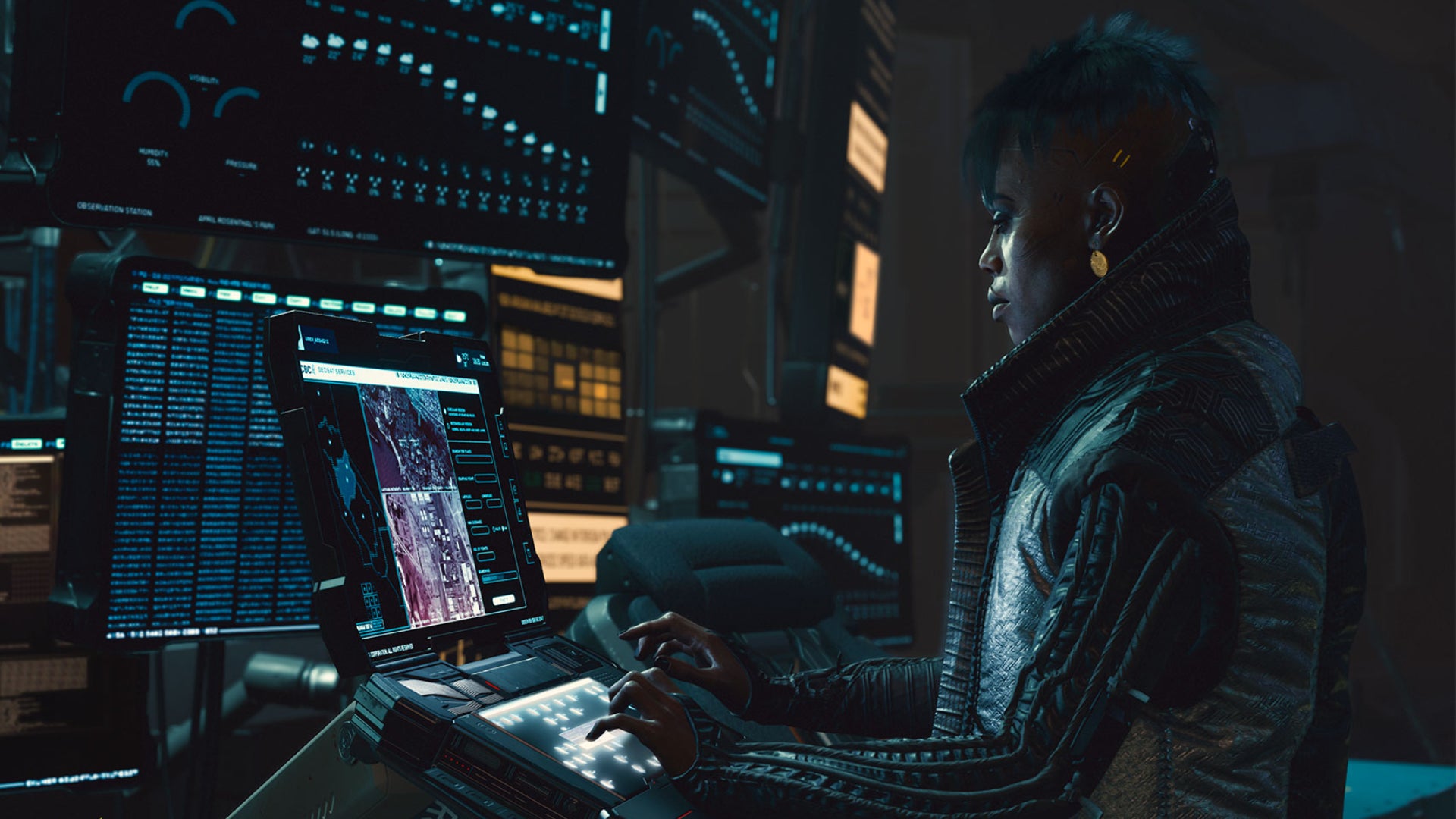 A hacker character sits and works at one of many monitors in Cyberpunk 2077.