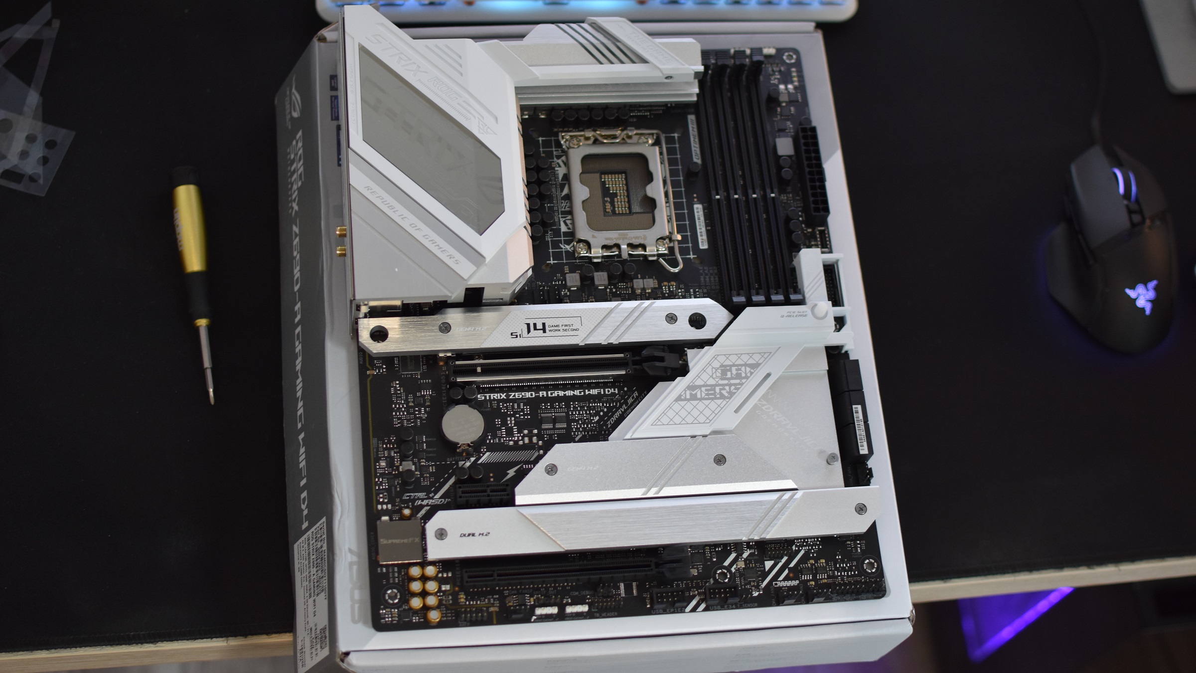 The Asus ROG Strix Z690-A Gaming WiFi D4 motherboard on a desk.