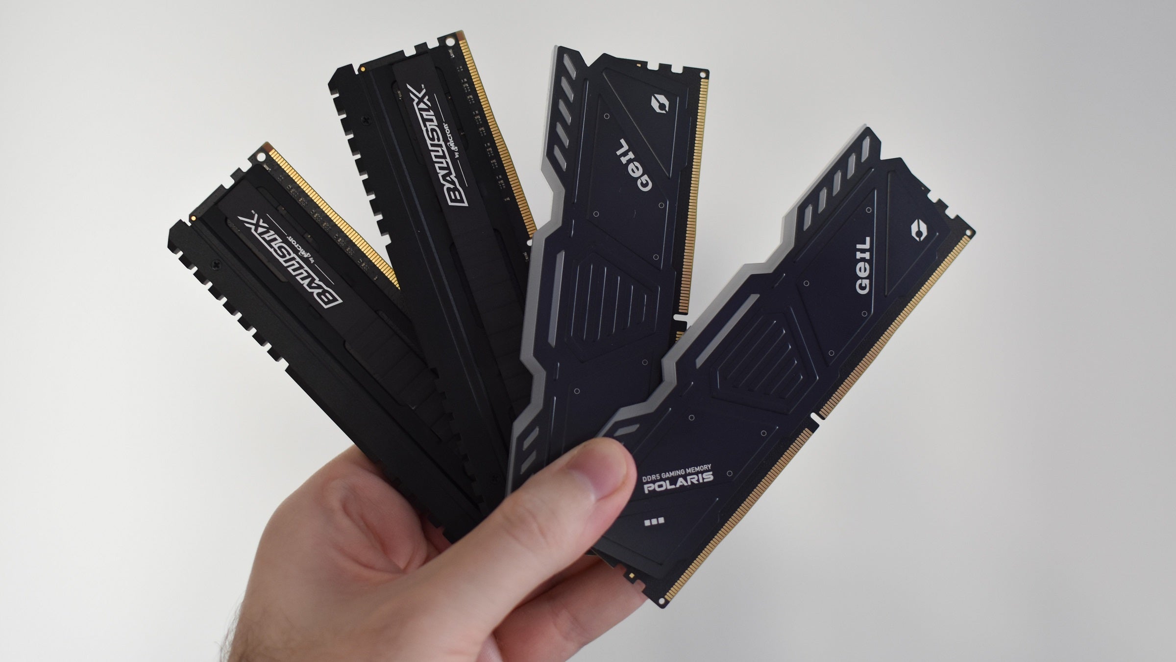 Some DDR4 and DDR5 RAM modules being held up.