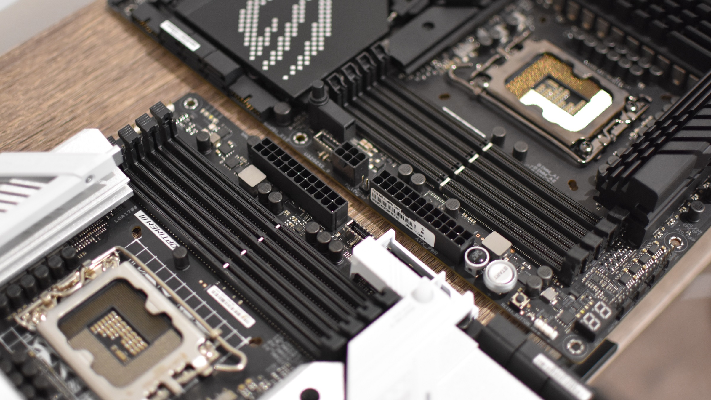 The RAM slots of two motherboards, one supporting DDR4 and one DDR5.