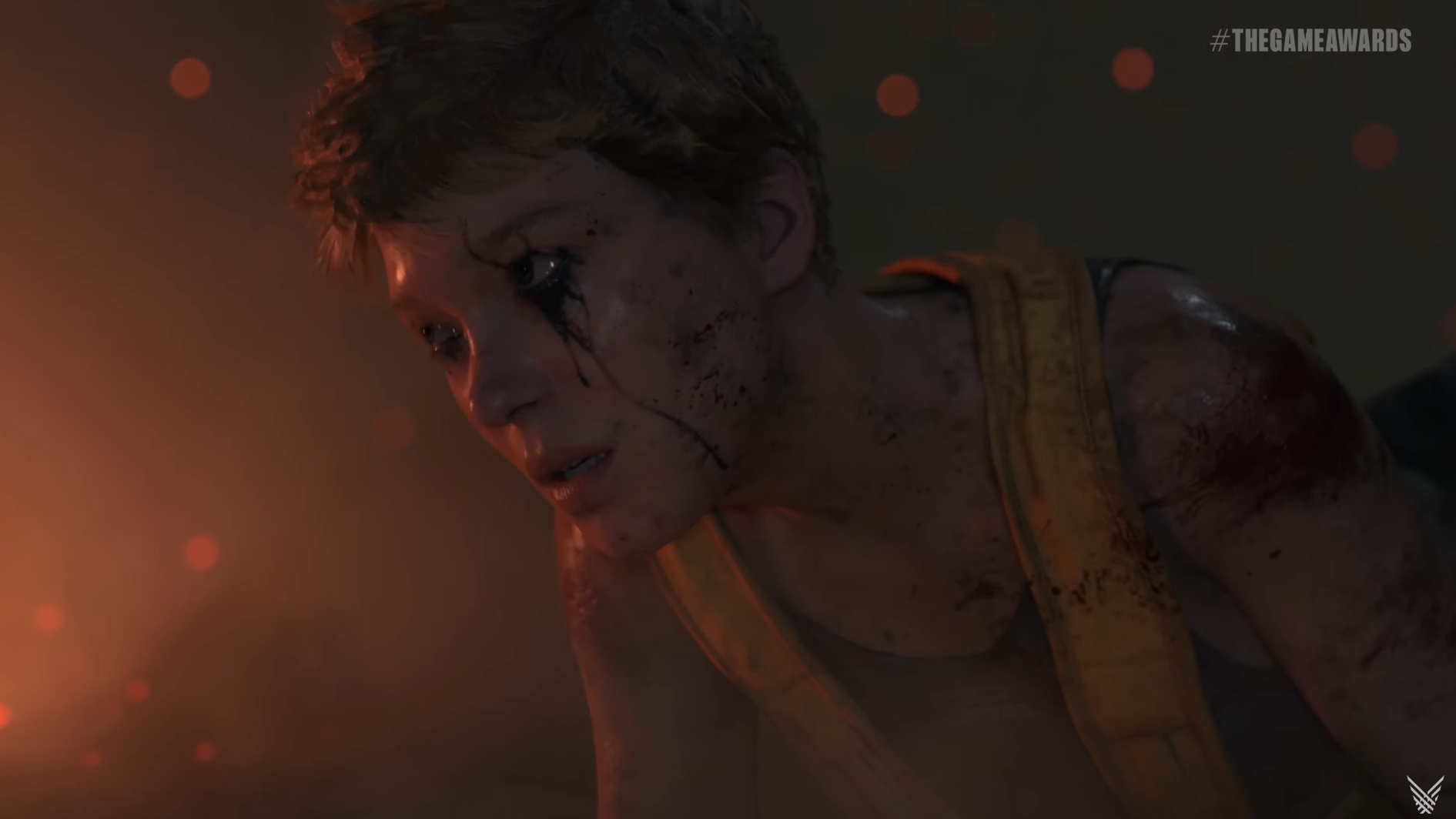 A woman with ink around her eyes crawls forward in Death Stranding 2