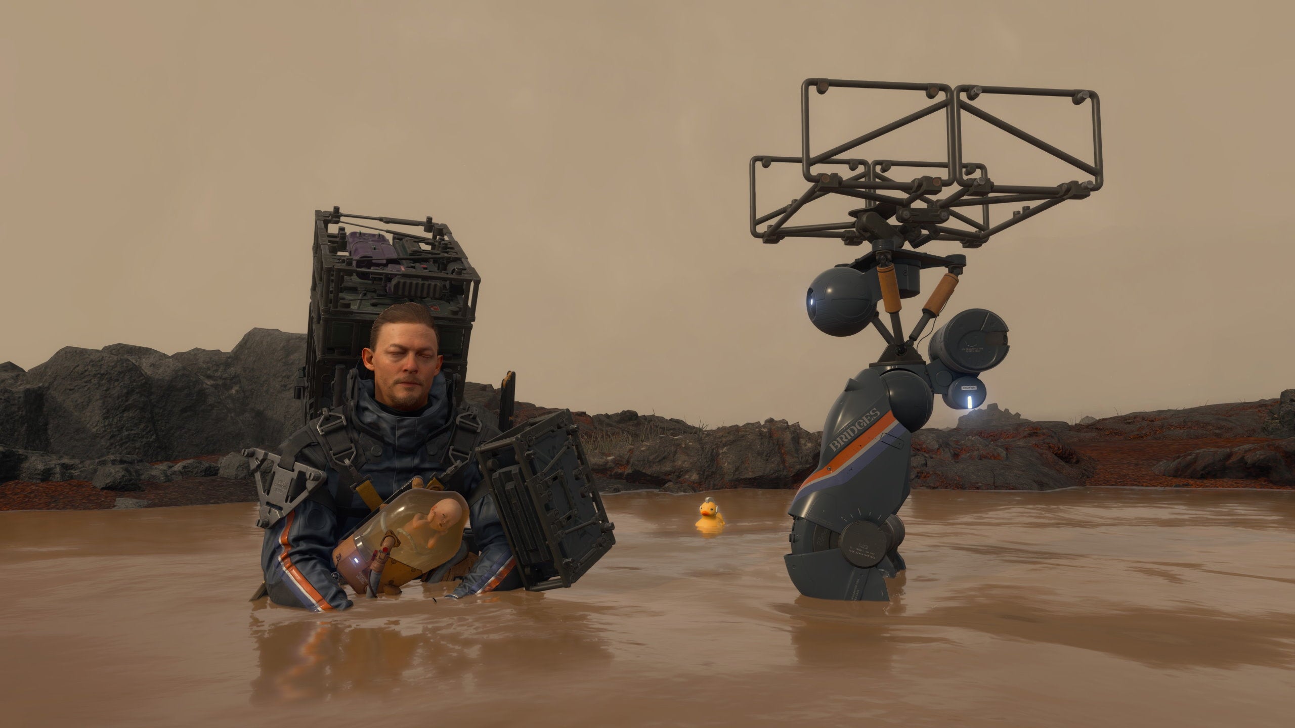 Sam sits in a hot spring with BB and Buddy Bot in Death Stranding Director's Cut