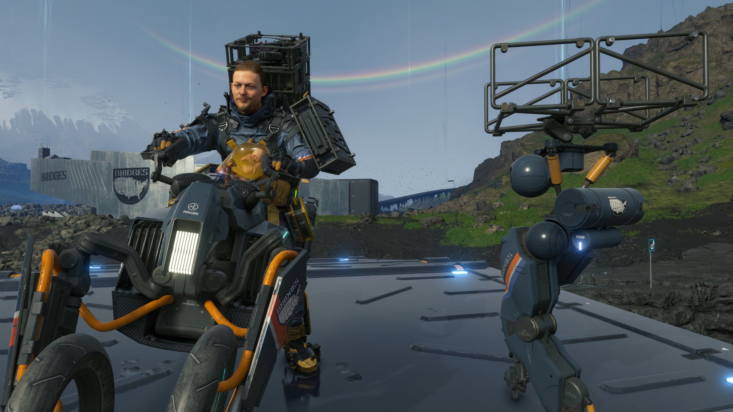 Sam rides a bike with a buddy bot in tow in Death Stranding Director's Cut