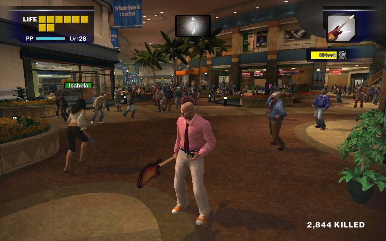 Frank West stands in the middle of a zombie infested mall holding both his camera and an electric guitar