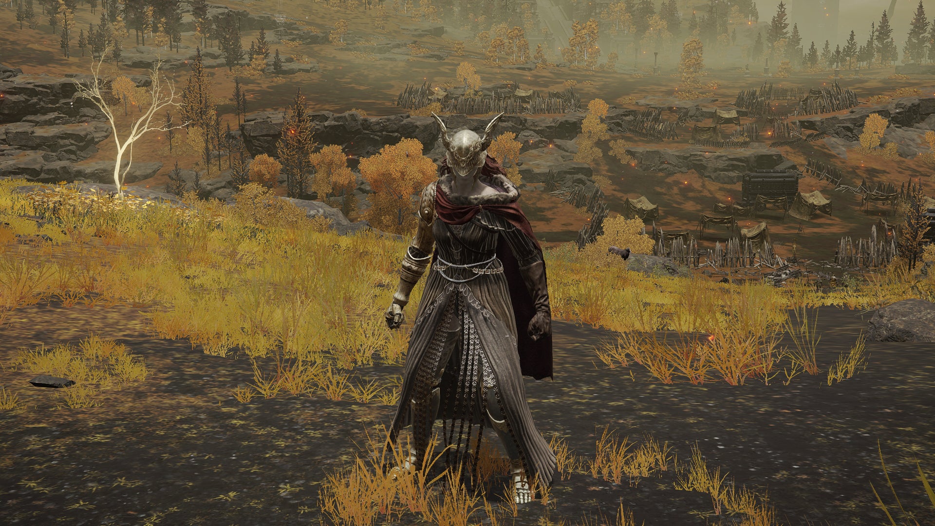 The player in Elden Ring stands in front of the camera wearing the Malenia armour set. Behind them is a view of the Altus Plateau.