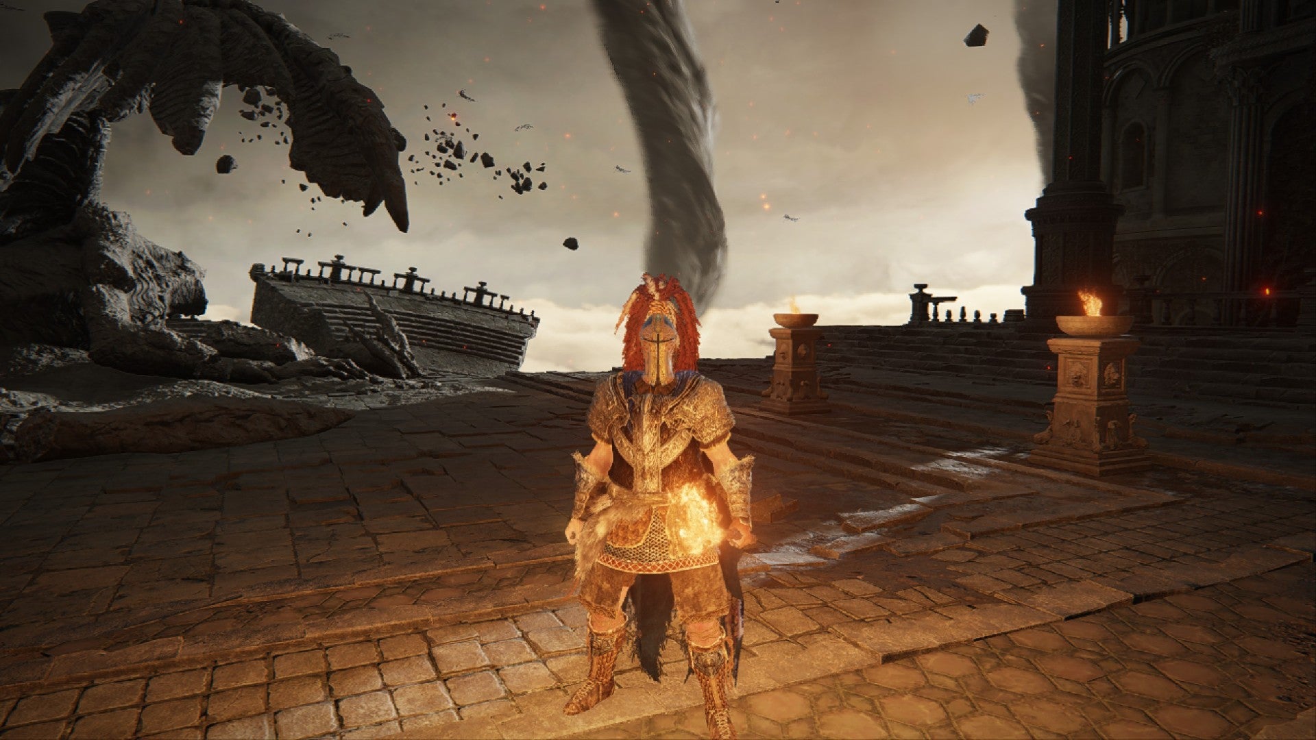 Elden Ring player stands by a stone dragon while a tornado rages in the background.
