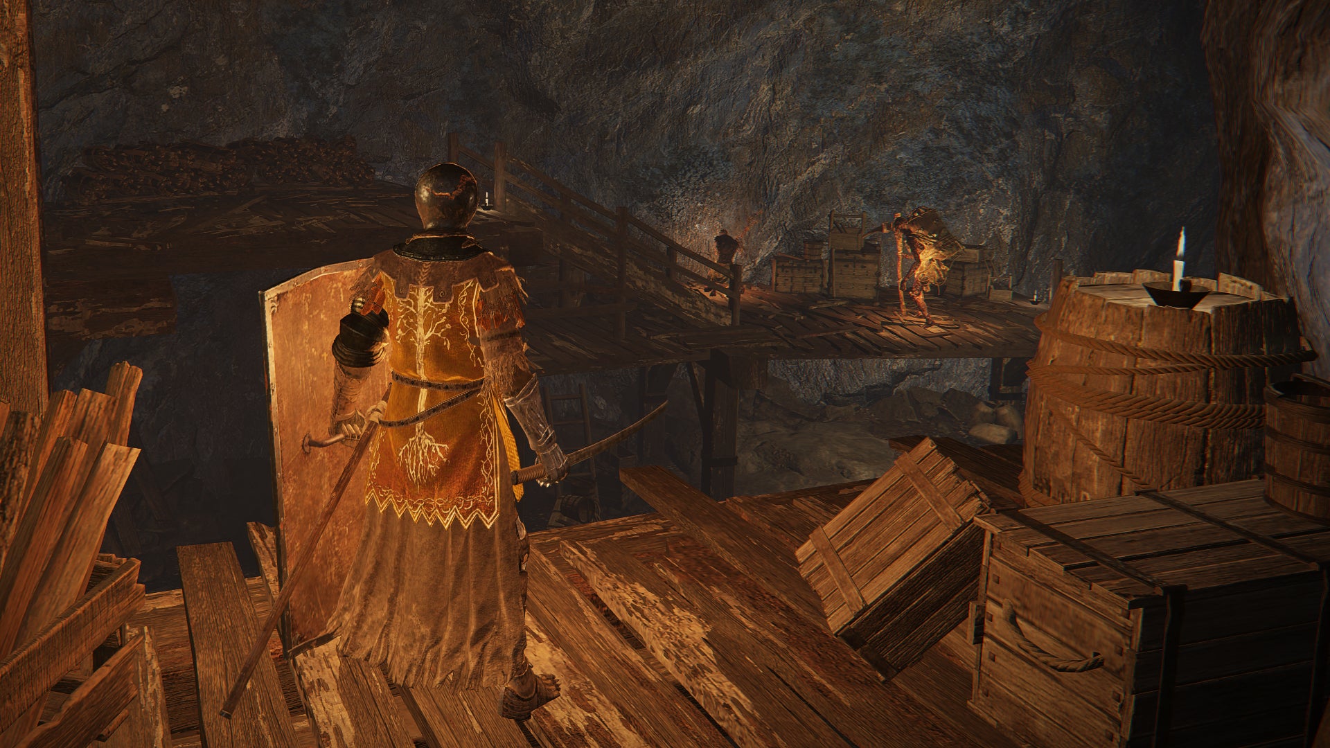 A mining cave in Elden Ring. The player stands on a wooden platform in the foreground, watching miner enemies at work in the background.