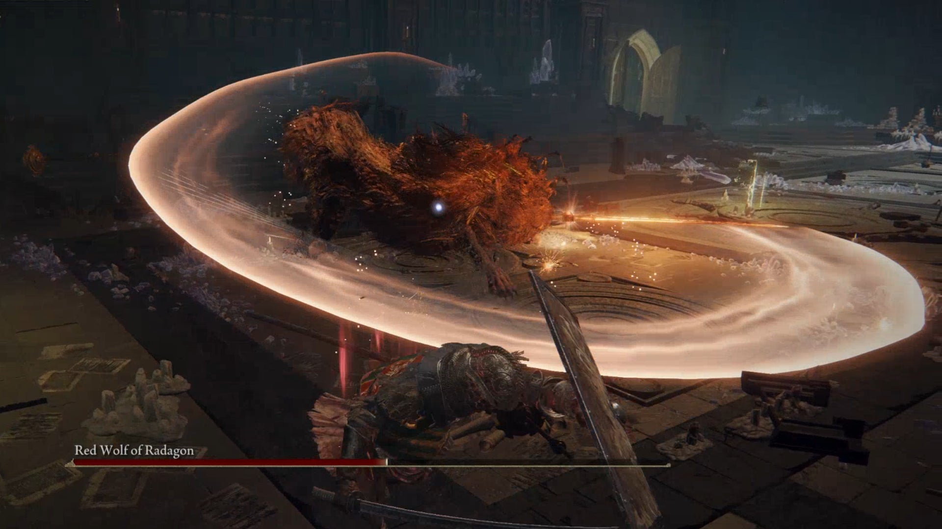 The Red Wolf of Radagon, a boss in Elden Ring, swings a flaming sword in an arc towards the player.