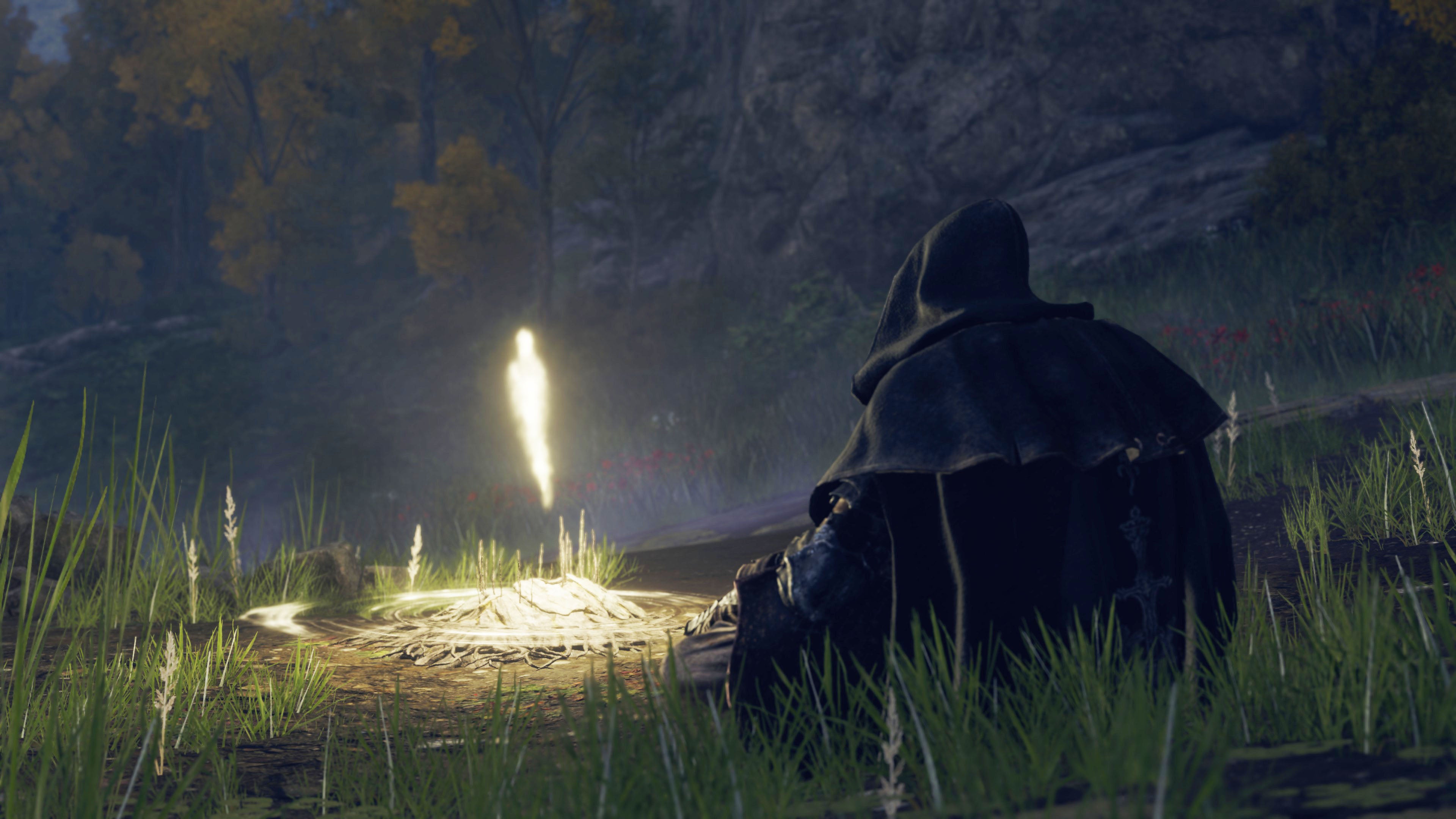 A hooded warrior rests at a glowing site of grace in Elden Ring