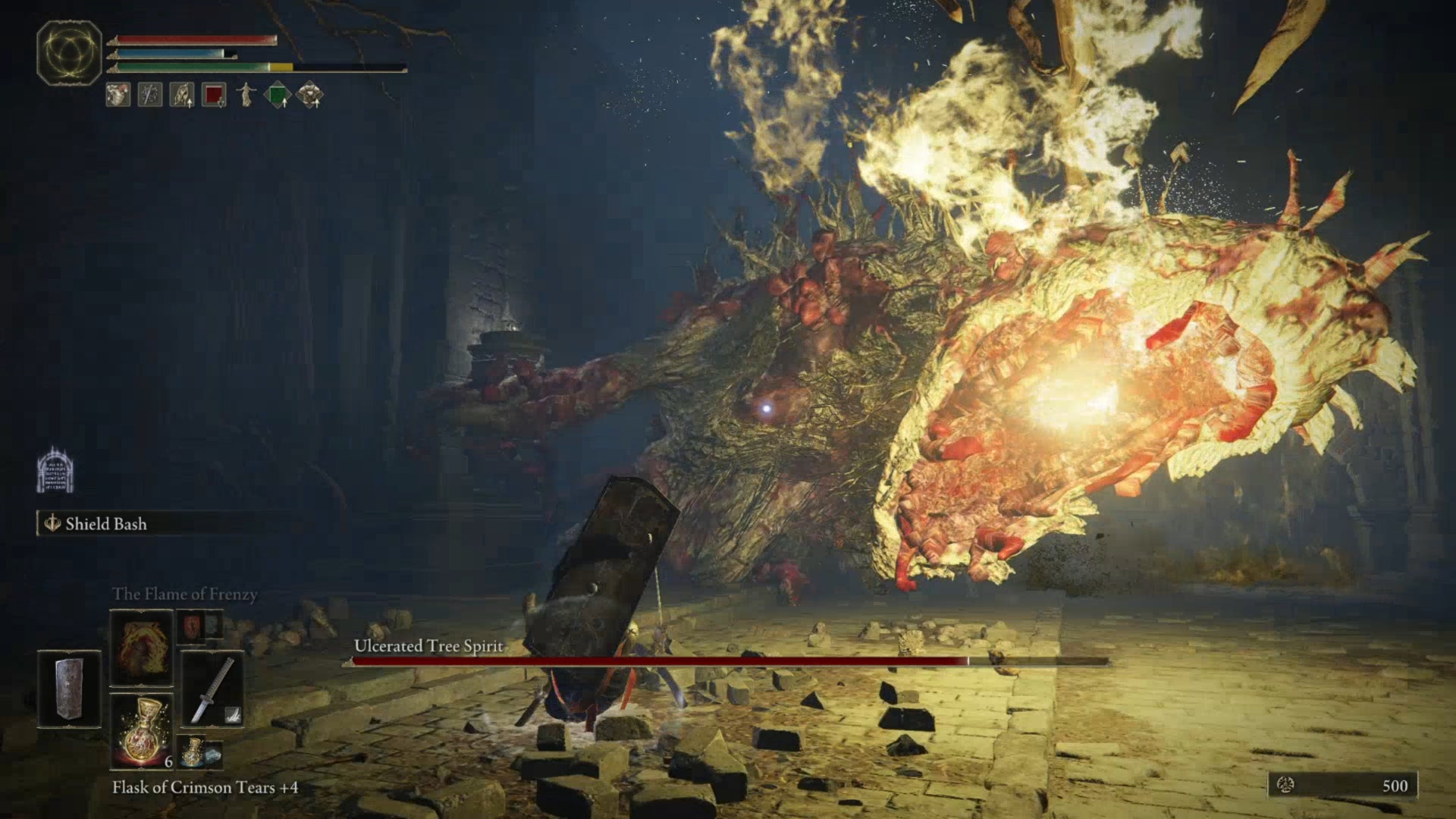 The Ulcerated Tree Spirit, a boss in Elden Ring, breathes fire towards the player.