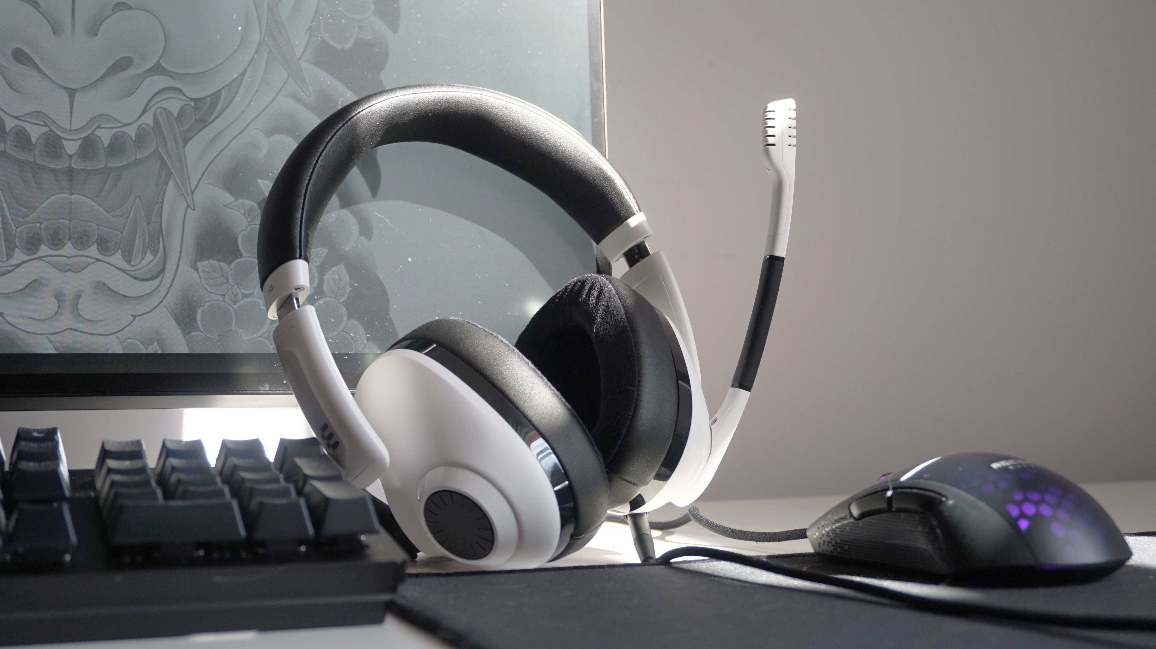 The EPOS H3 gaming headset on a desk next to a keyboard, mouse and monitor