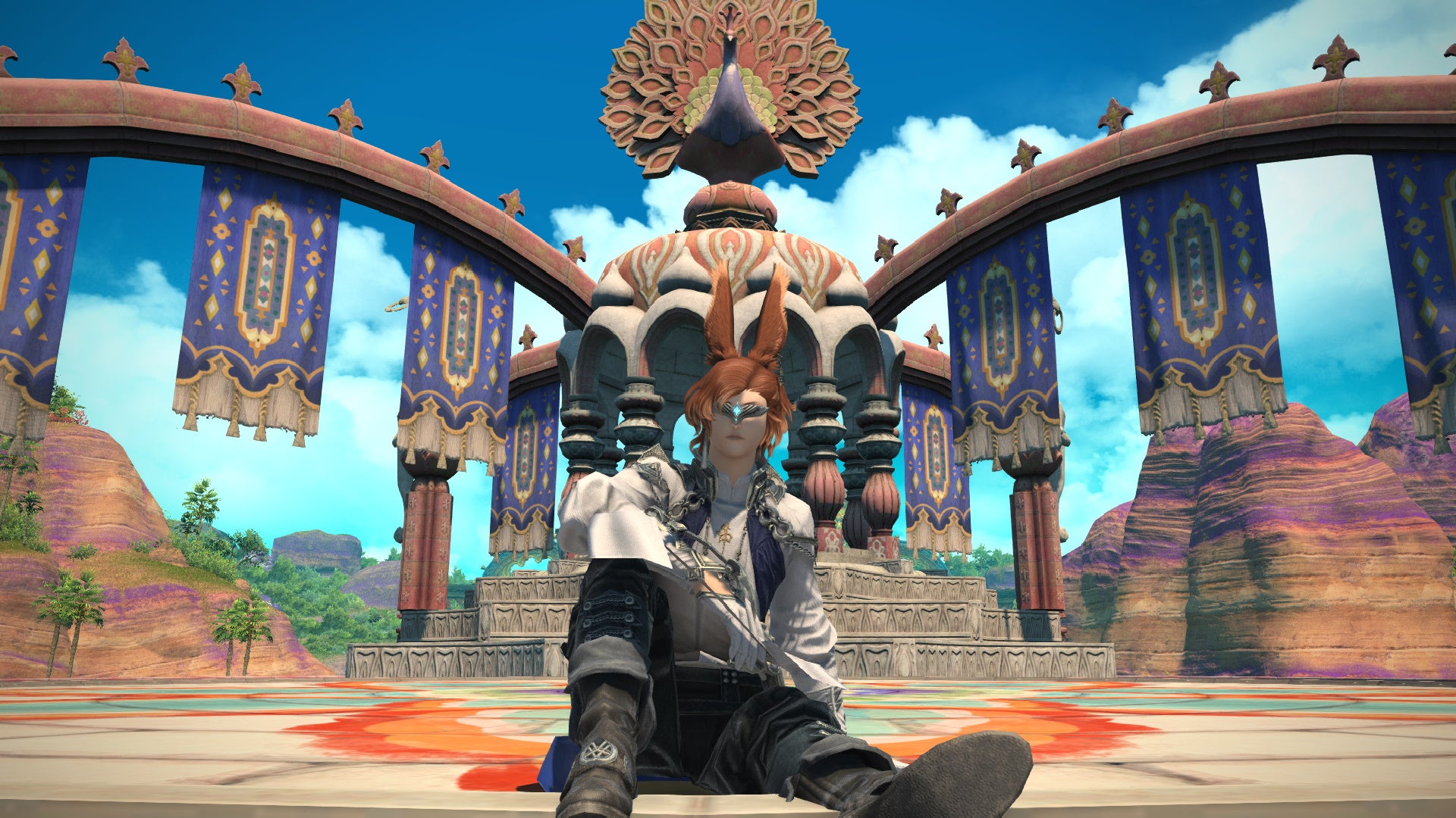 A male Viera sits back in front of a colourful peacock monument in Final Fantasy XIV: Endwalker.