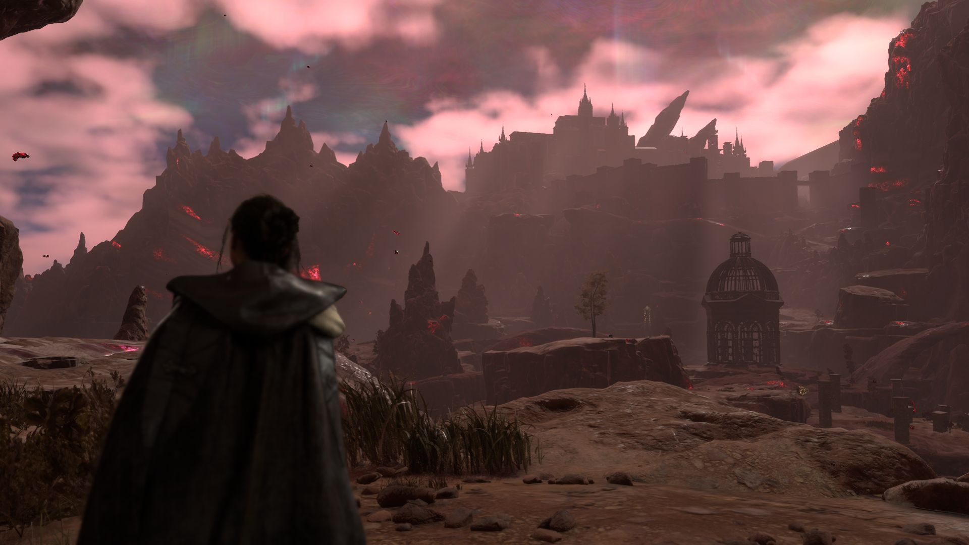 Frey, Protagonist of Forspoken, is standing looking at the terrifying black and gray rock landscape, a castle in the distance.  There are red clouds in the sky and red particles floating in the air