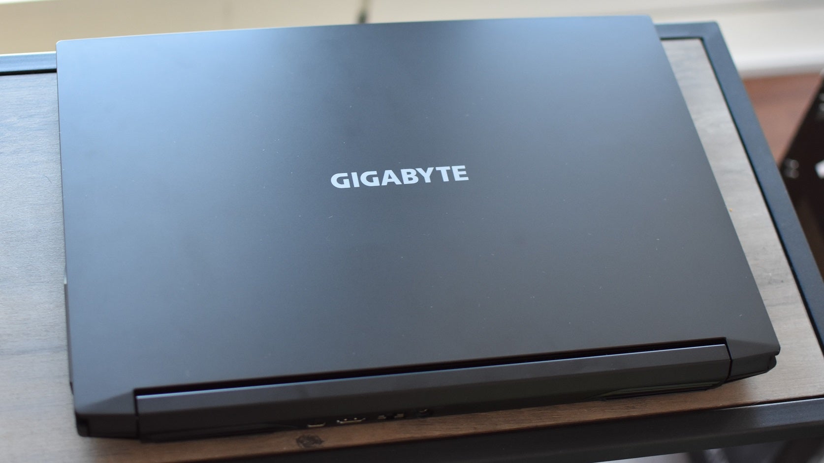 The Gigabyte G5 gaming laptop, sat on a small table with its lid shut.
