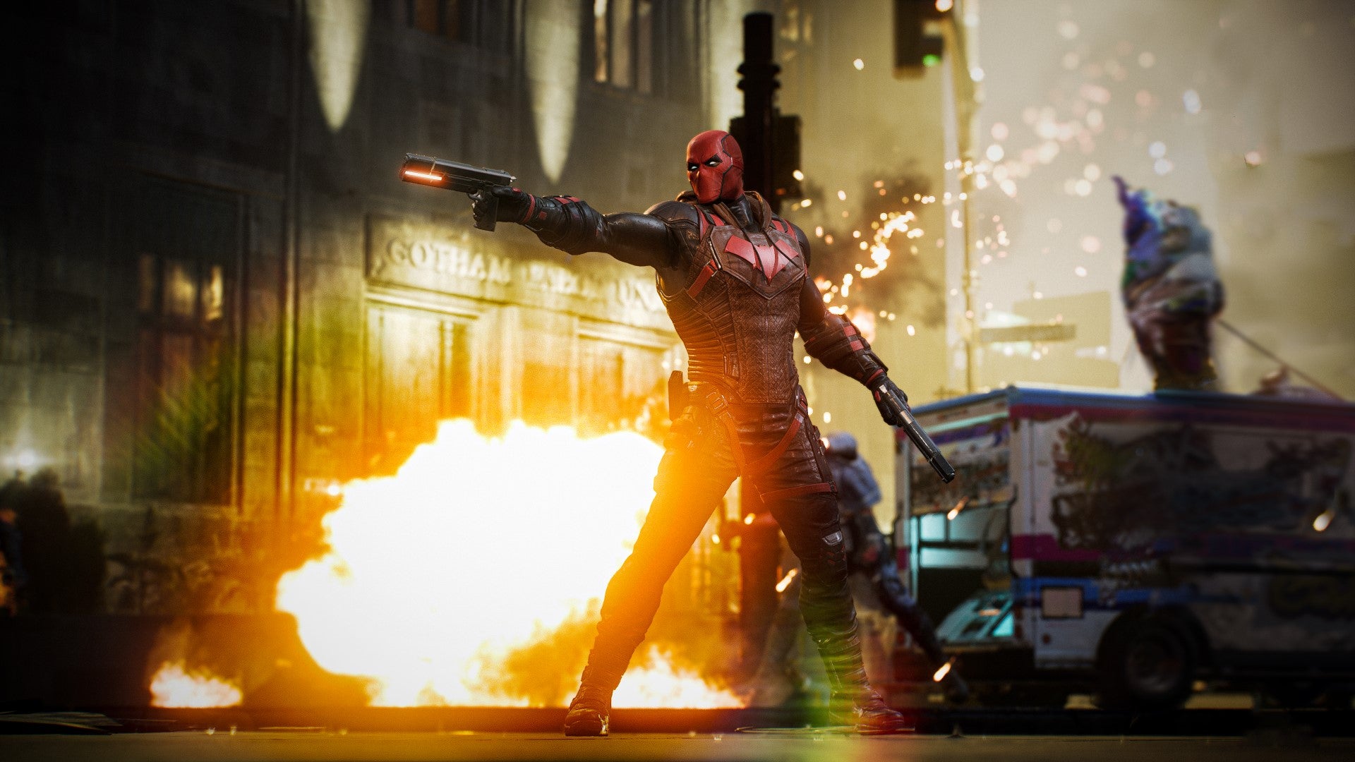 Red Hood fires off a shot as an explosion goes off behind him.