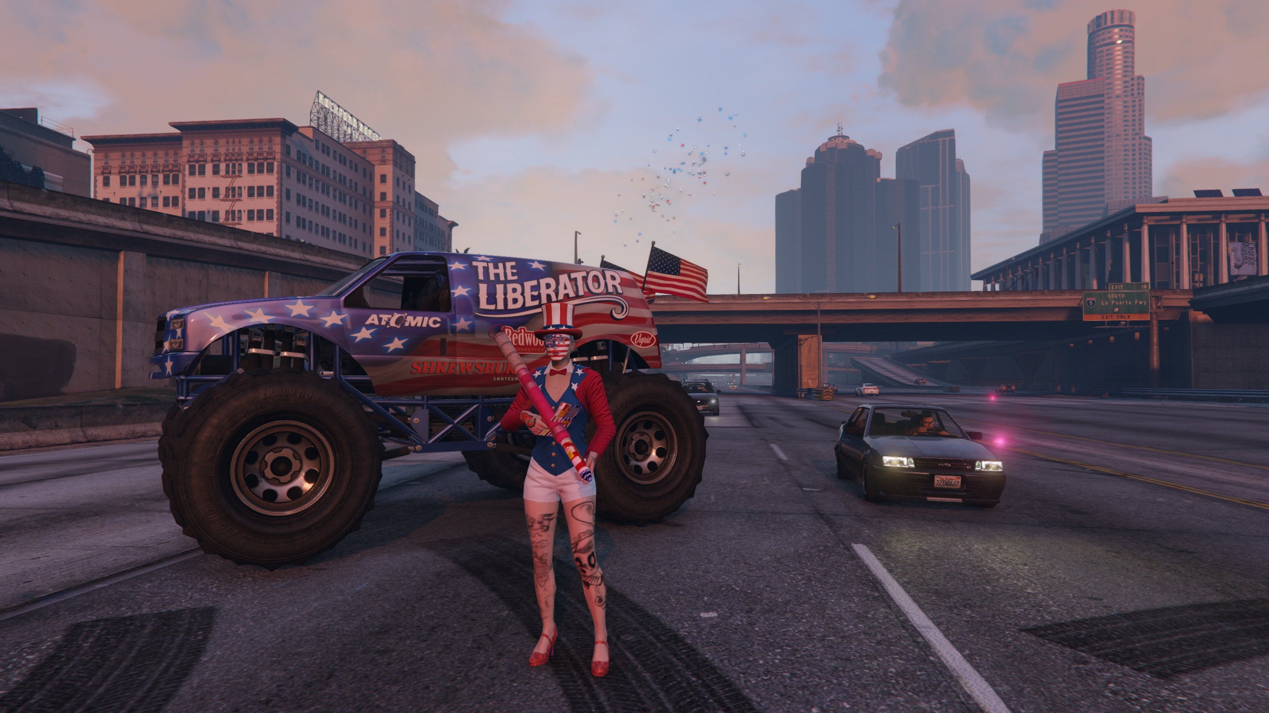 Uma mulher vestida com um traje patriótico americano segura um baooka de fogos de artifício na frente de um caminhão monstro pintado com as estrelas e listras em uma captura de tela do GTA Online.