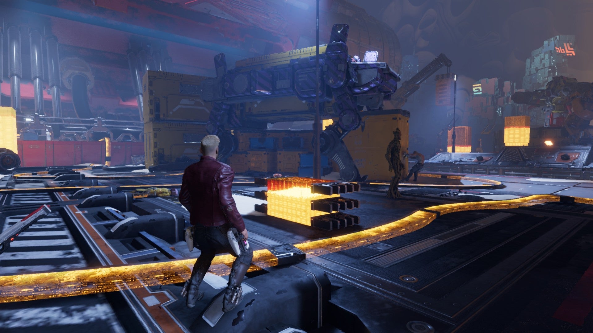 Star-Lord stood on a yellow cable whilst Drax moves container into position. Groot stands nearby