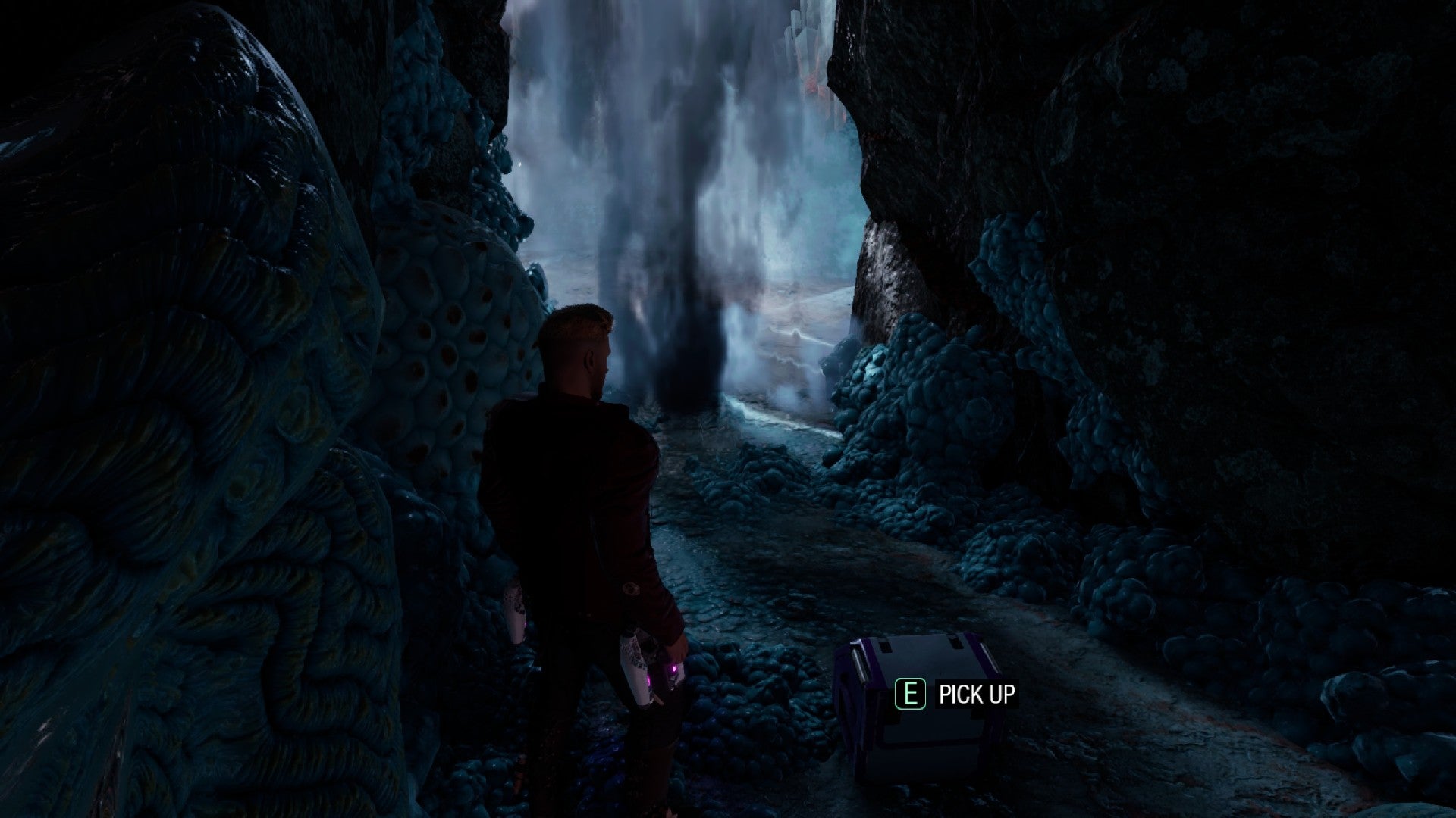 Star-Lord stood next to outfit box inside a waterfall.