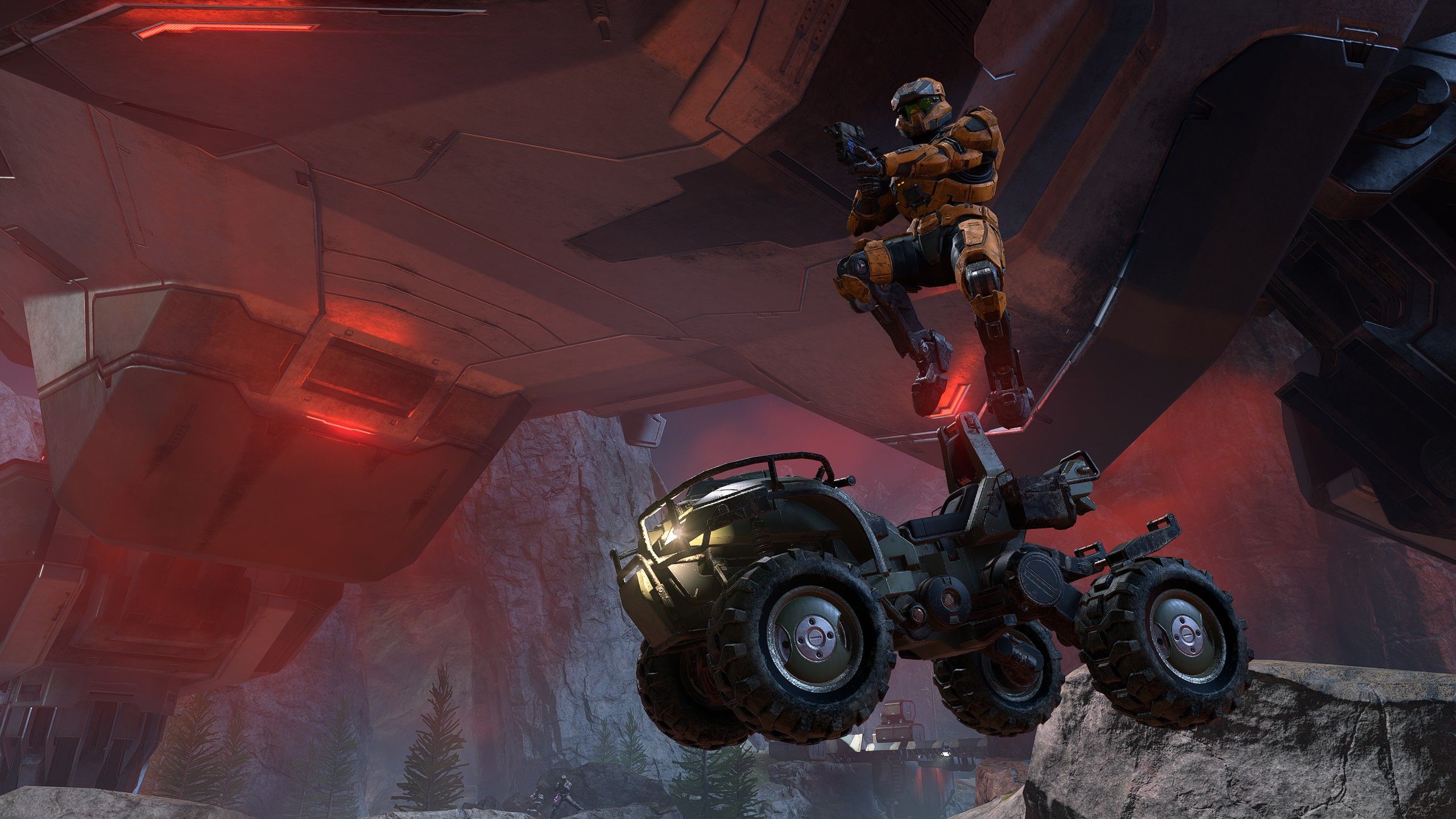 A spartan in Halo Infinite leaps from a warthog vehicle, gun ready