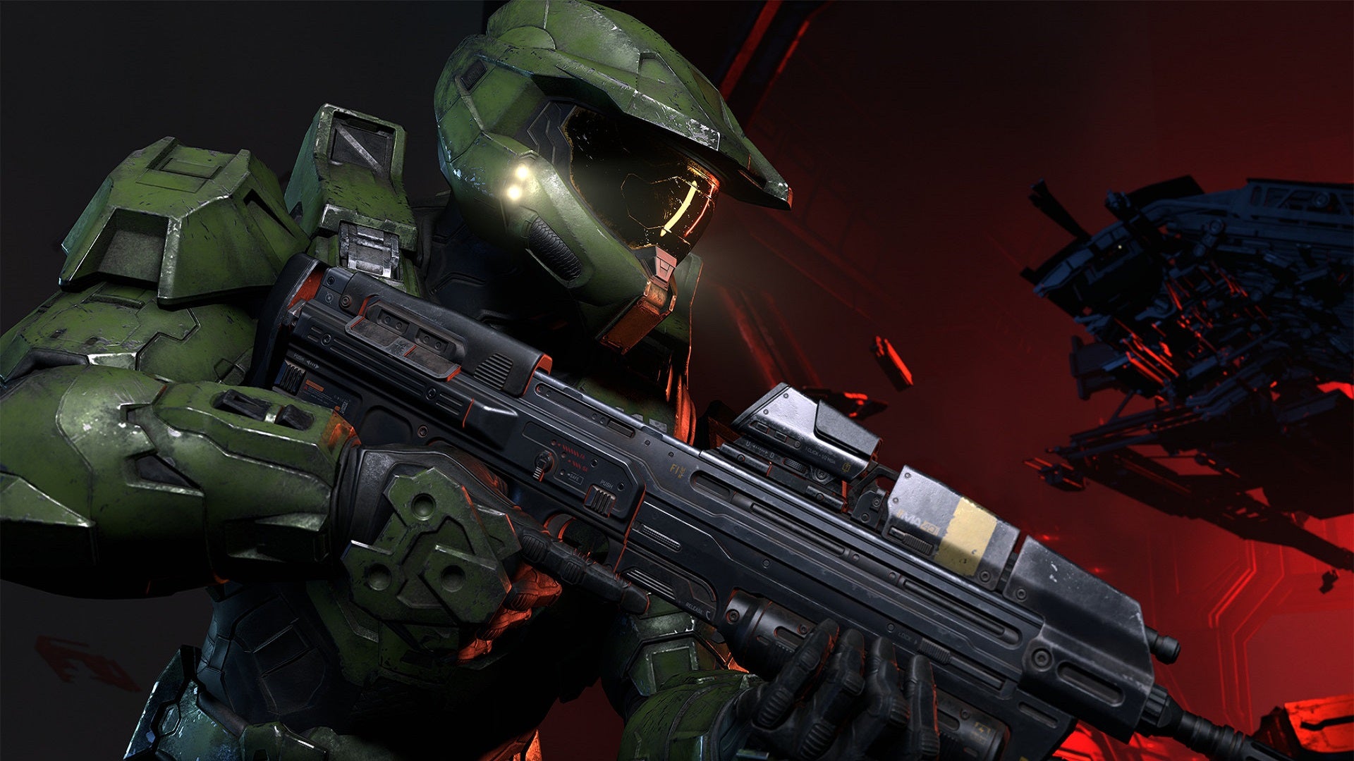 A Spartan in green armor wields the standard MA40 Assault Rifle in a promotional image for Halo Infinite.