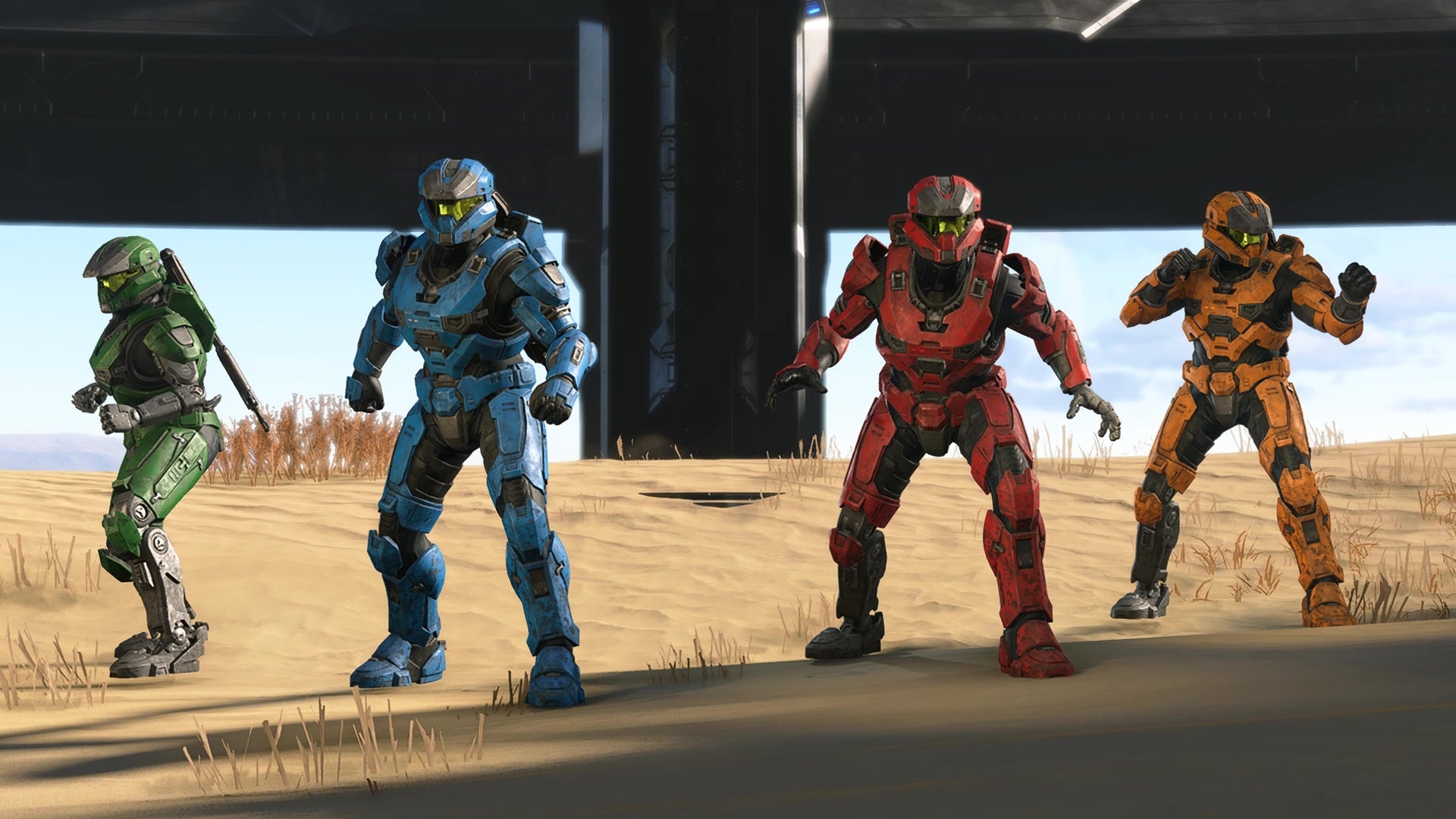 Quatro espartanos, todos com cores primárias de rock, estão prontos para a batalha em Halo Infinite.