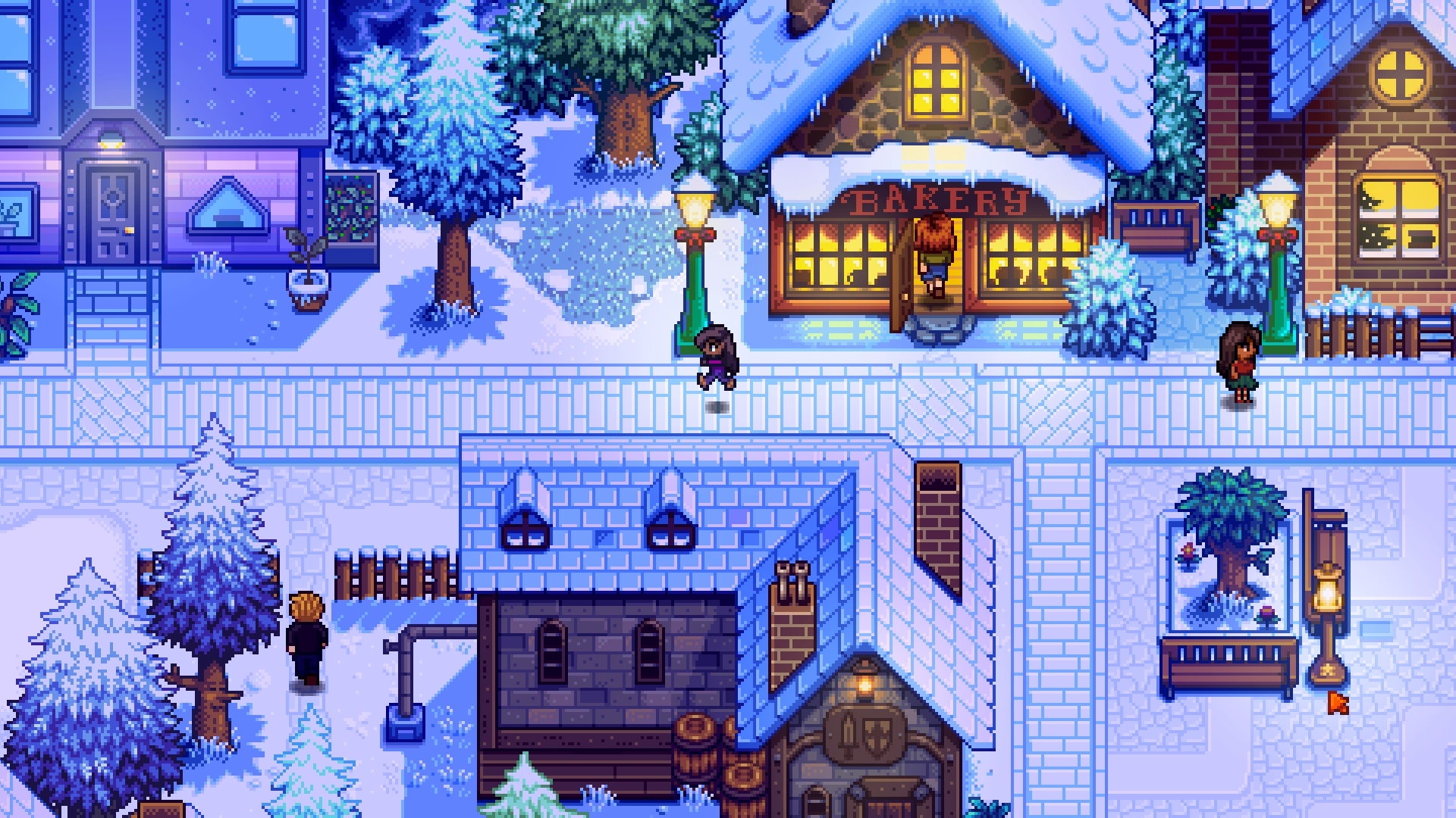 A screenshot of Haunted Chocolatier, the new game from the developer of Stardew Valley, showing a character in a snowy town at night, walking outside a quaint and cosy bakery.