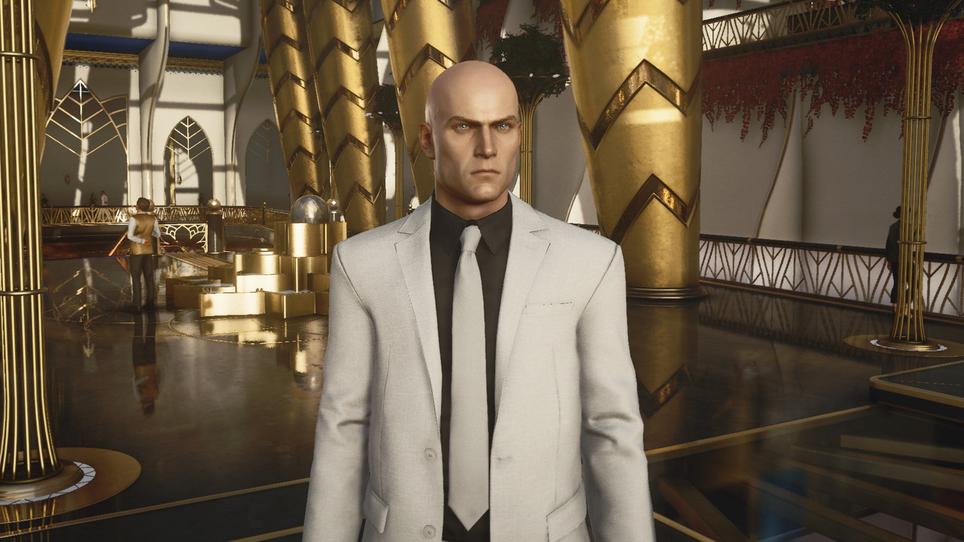 A screenshot of Agent 47 in a sharp looking suit from Hitman 3's Dubai level