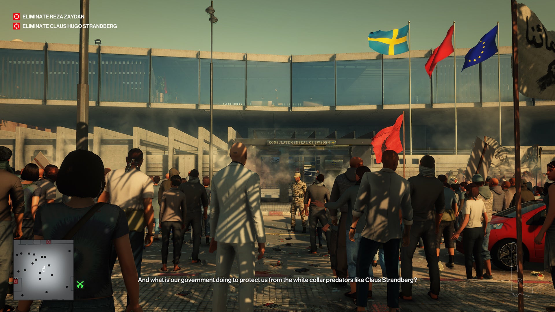 A screenshot of Ian Hitman approaching the Swiss consulate in Marrakesh, moving past an angry crowd outside the glass front doors