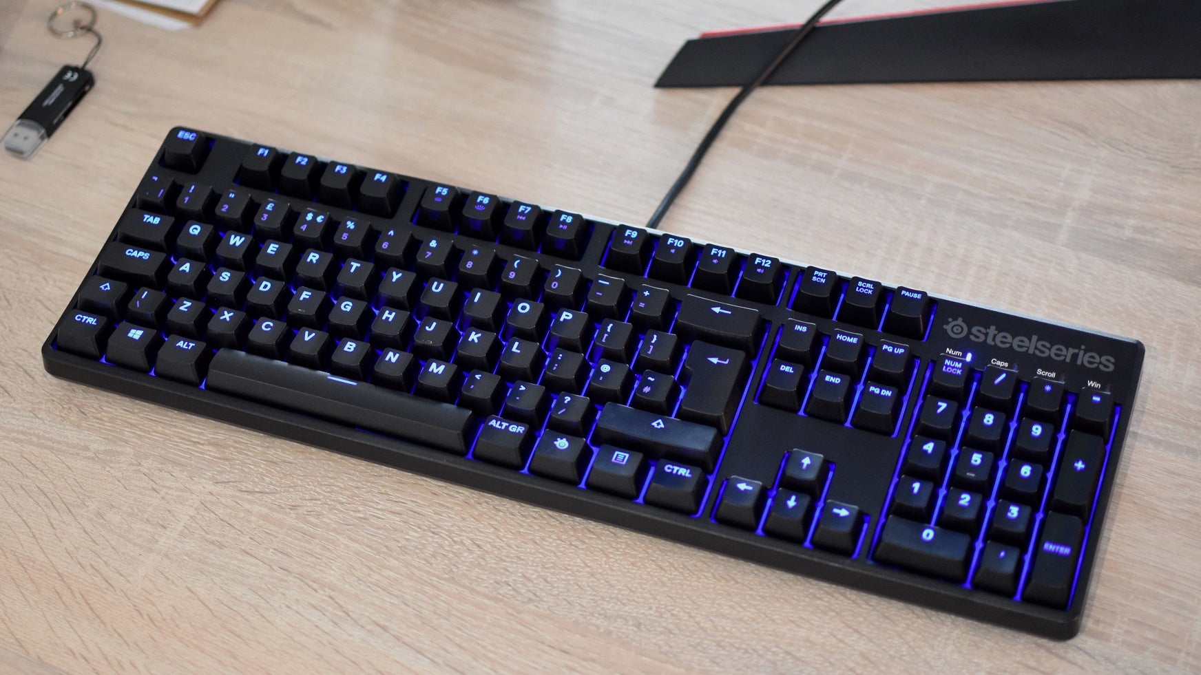 A freshly-cleaned keyboard sat on a desk.