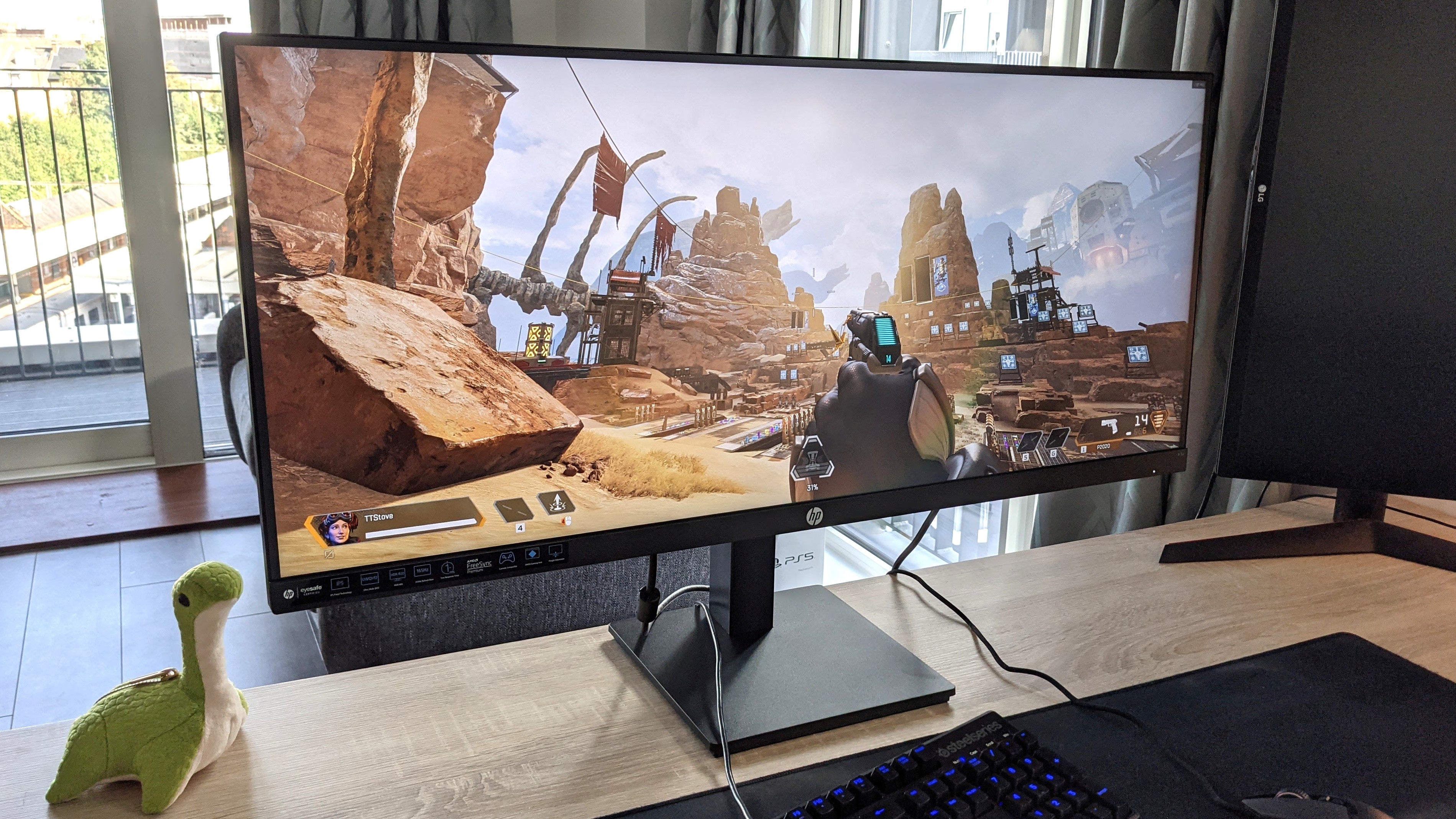 The HP X34 gaming monitor sitting on top of a desk while running Apex Legends.