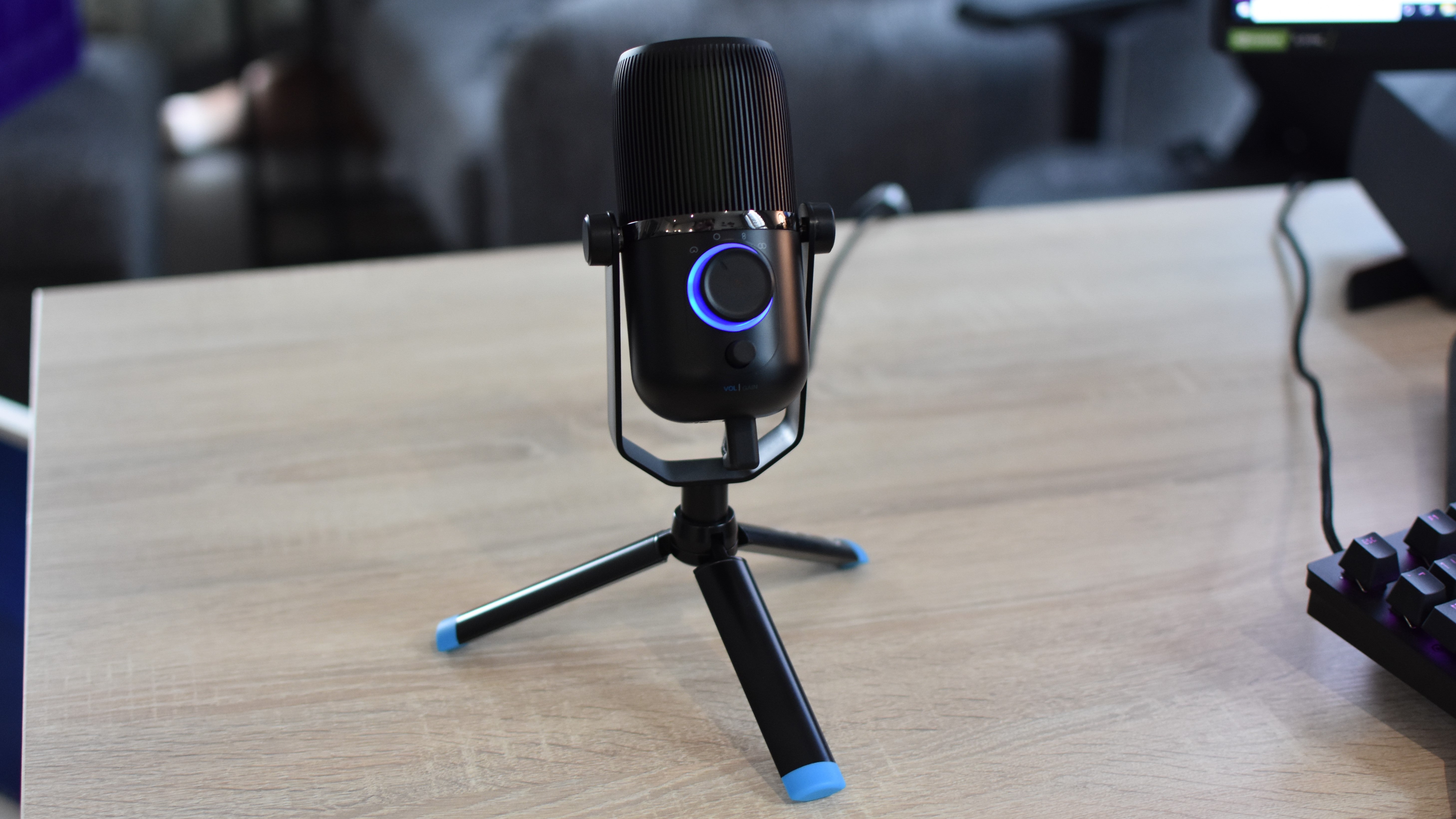 The JLab Talk microphone on a desk.