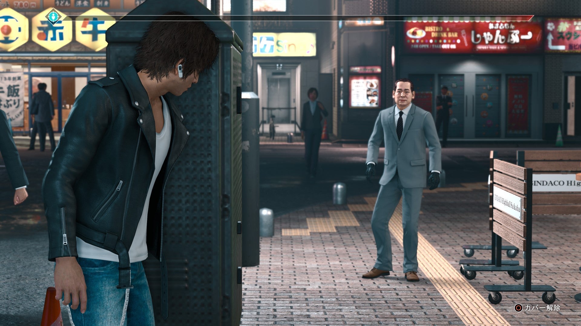 Yagami peers out of cover as he tails a suspect in Judgment.