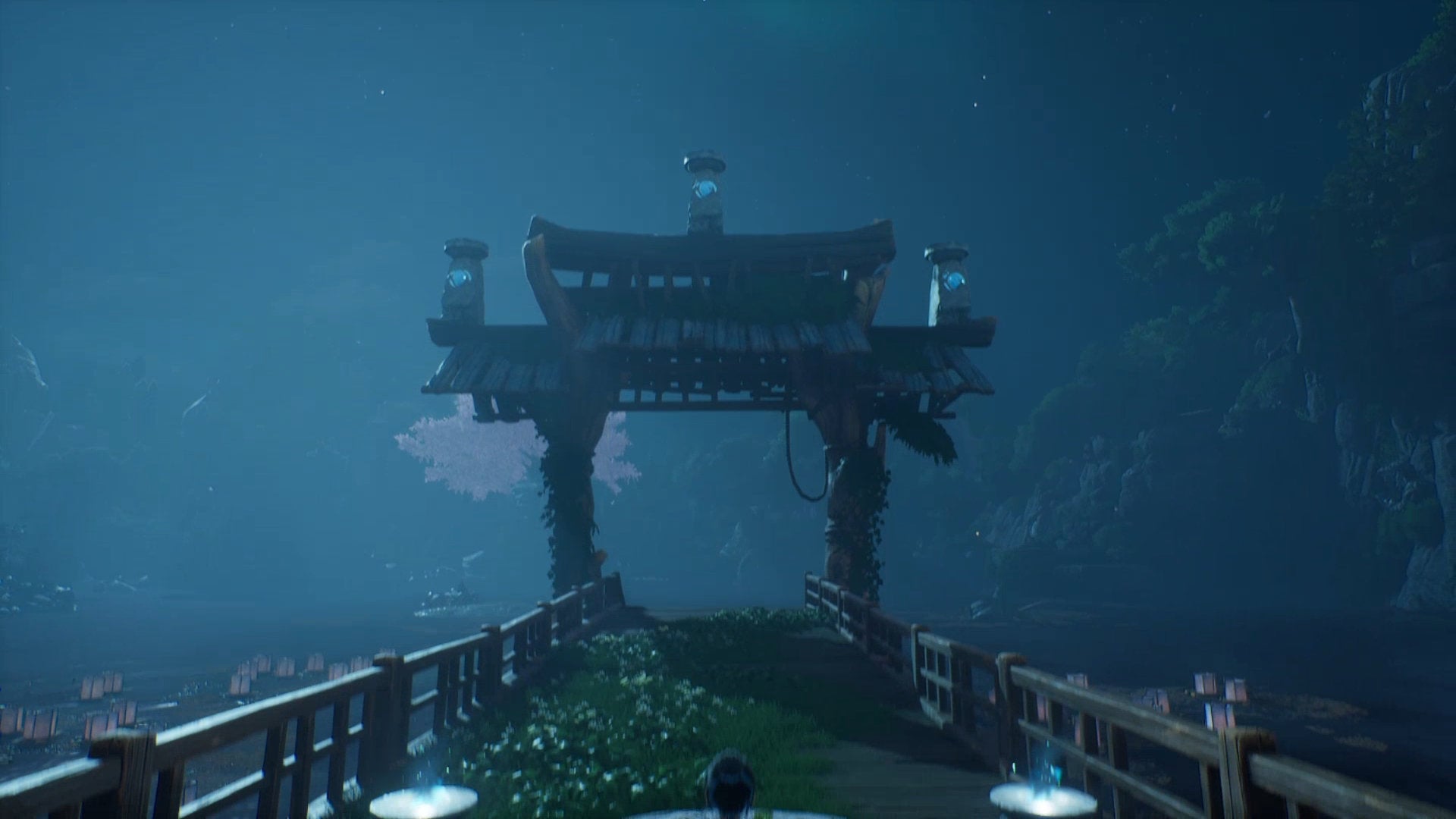 An archway at the start of the Warrior Path in Kena: Bridge Of Spirits, with three crystals on statues on top of the archway.