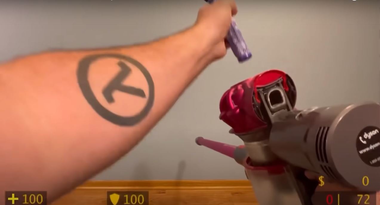 Man reloading a vacuum cleaner like a gun