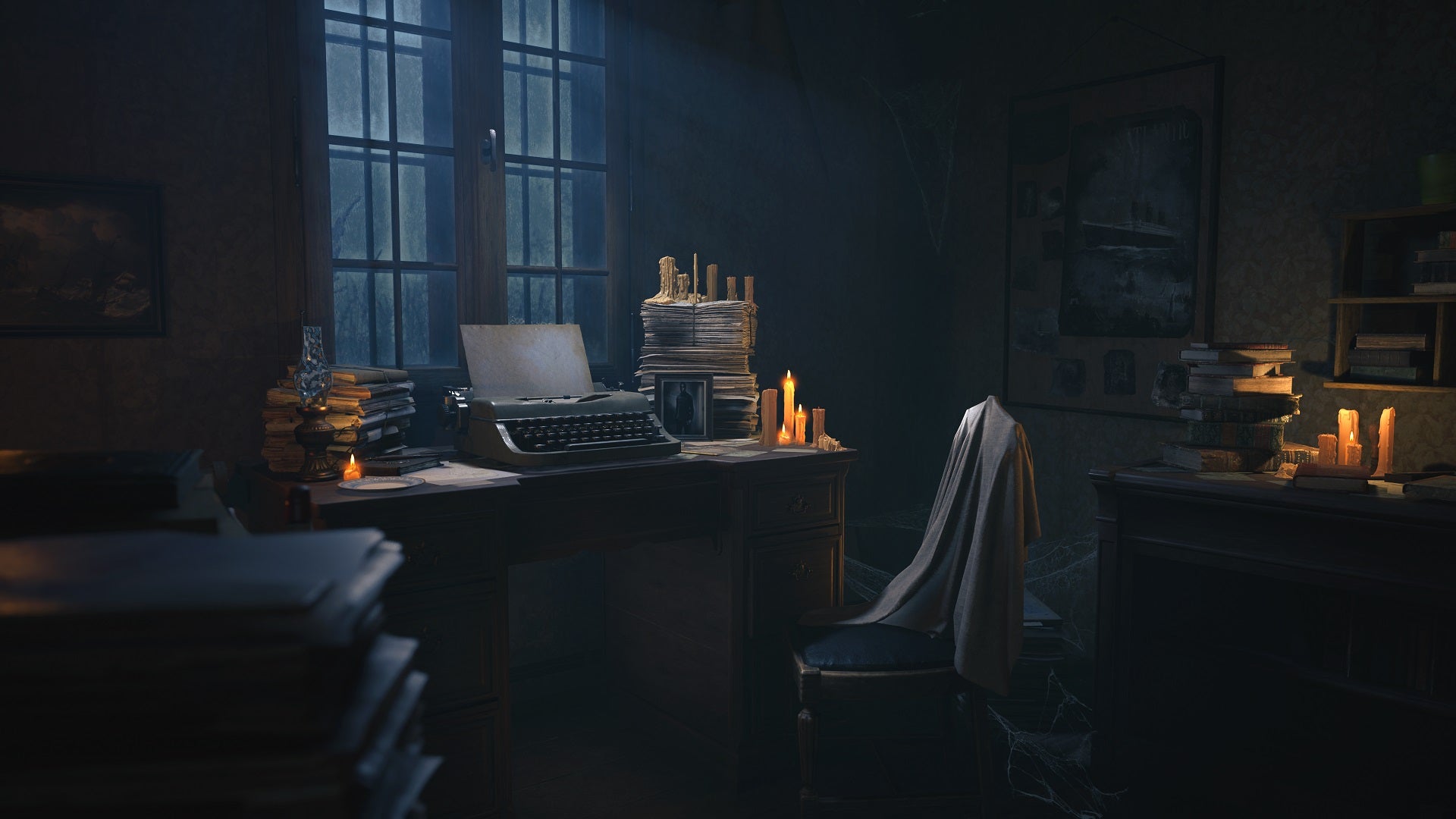 A dimly candle-lit room with a typewriter on a desk under the windows. It's dusk outside and a nearby chair has a shawl or blanket draped over it. The room is very cluttered with books, papers, and pictures on the walls. An unlit oil lamp sits on the table.