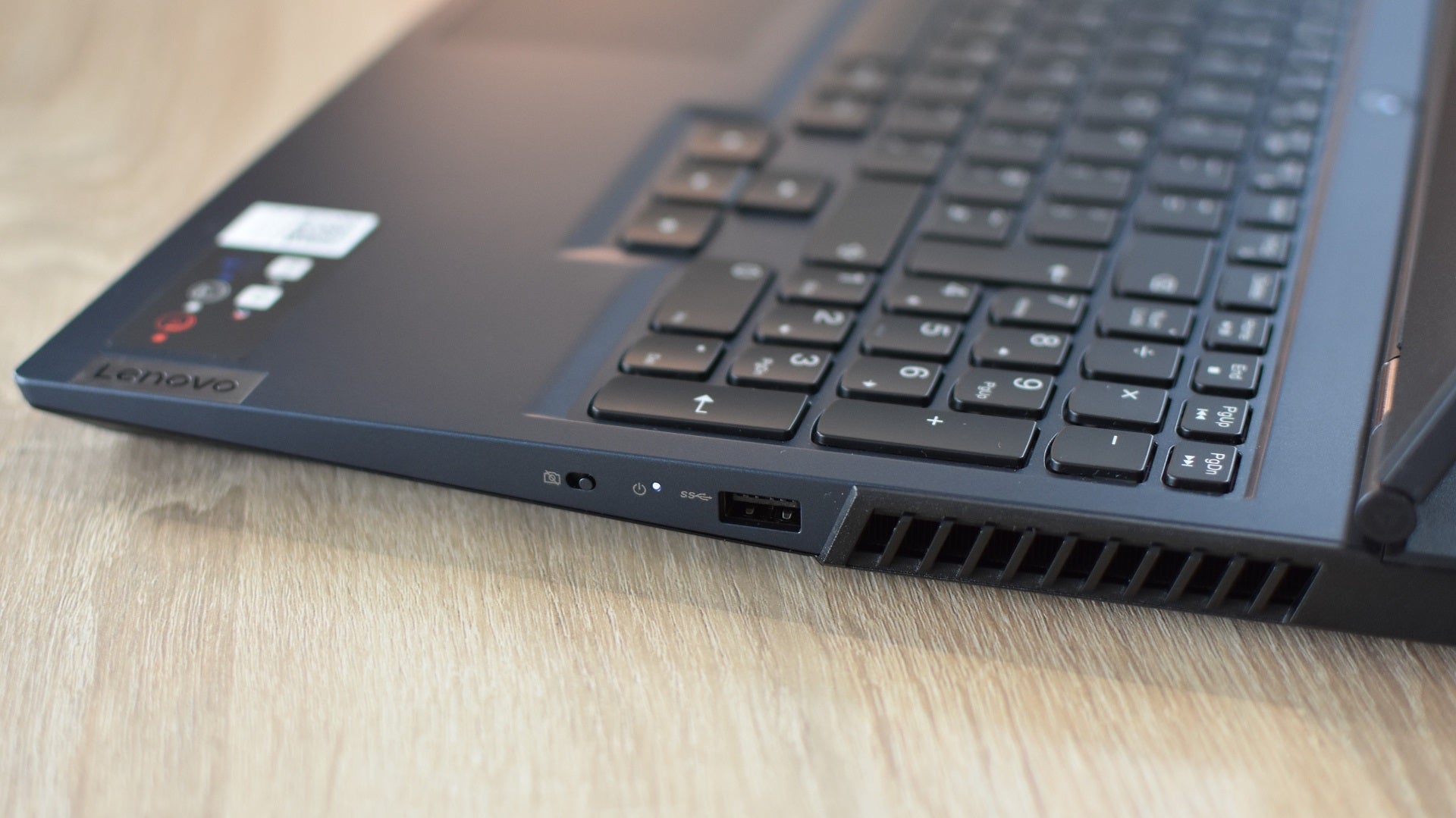 The right-side USB port, webcam killswitch and air vent on the Lenovo Legion 5 gaming laptop.