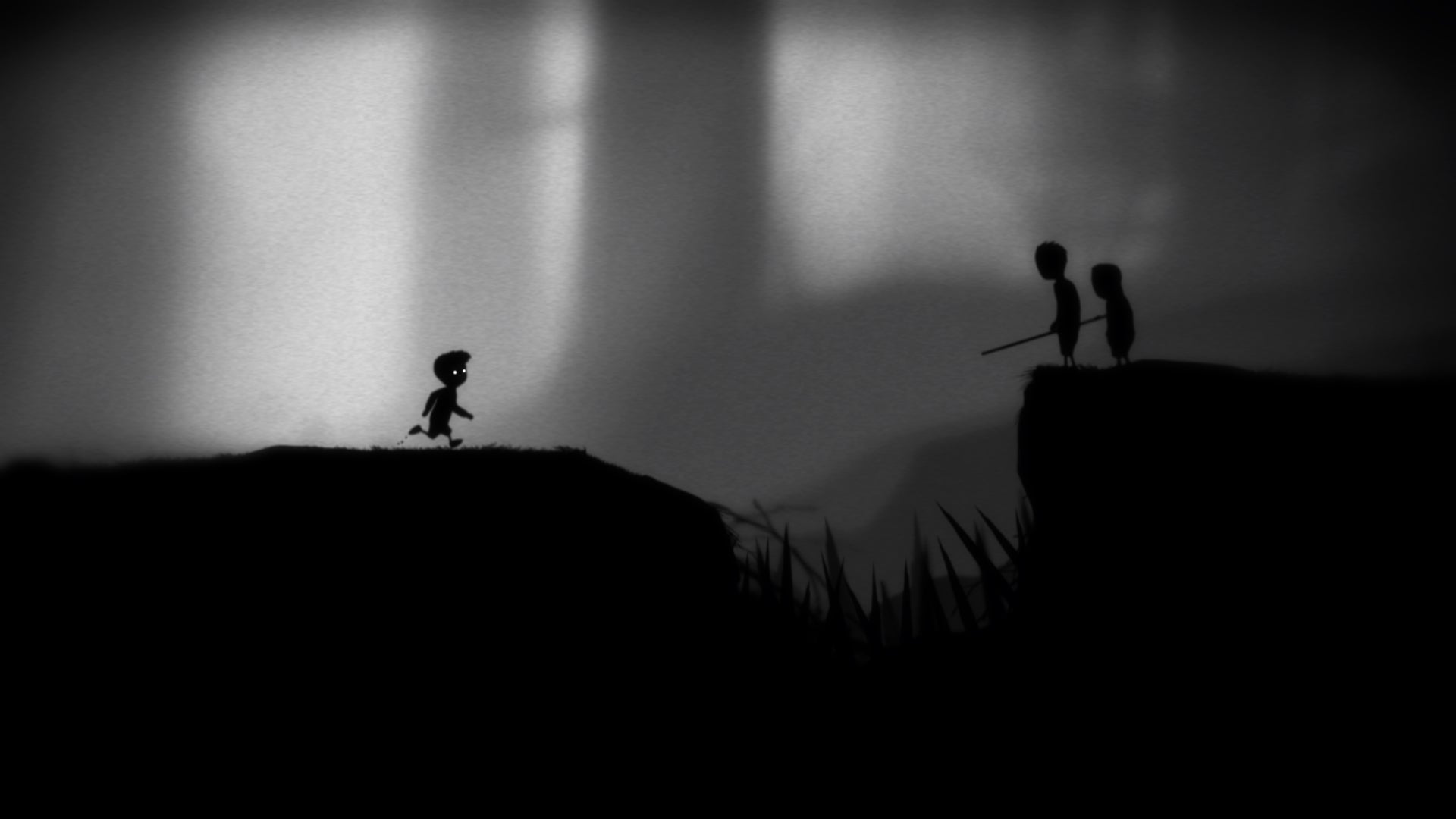 A boy looks on at two shadowy figures on the other side of a spiky chasm in Limbo