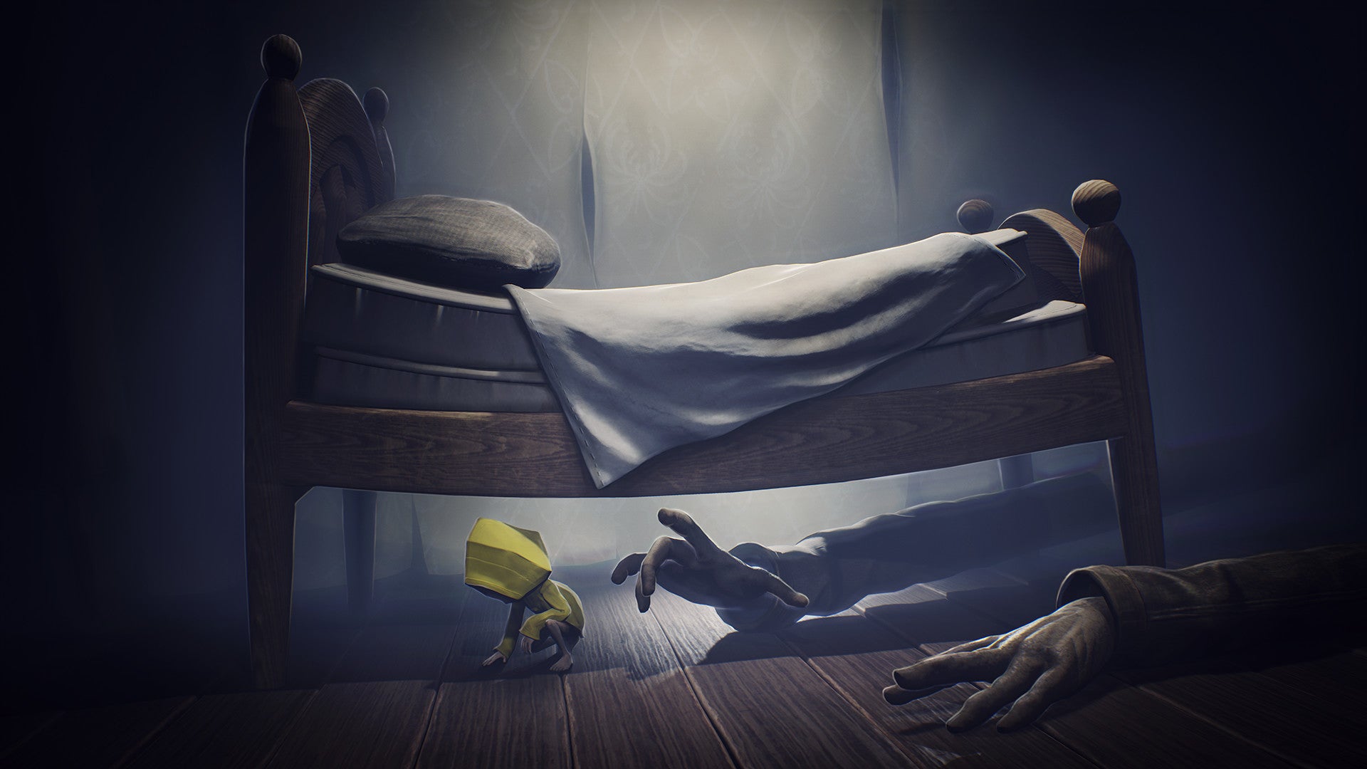 A screenshot of Little Nightmares showing a person in a yellow mac hiding under a giant bed while creepy long arms reach under to get them.