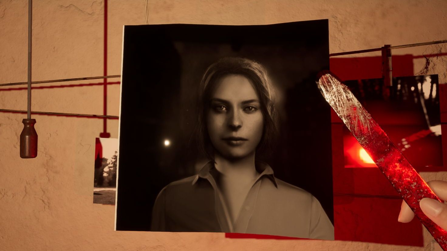 A black and white photograph of Martha, the titular girl from Martha Is Dead, is hung up to dry in a dark room by the player character.