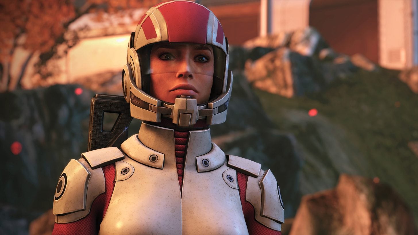 A close-up of a female Commander Shepard in a white and red space suit in Mass Effect