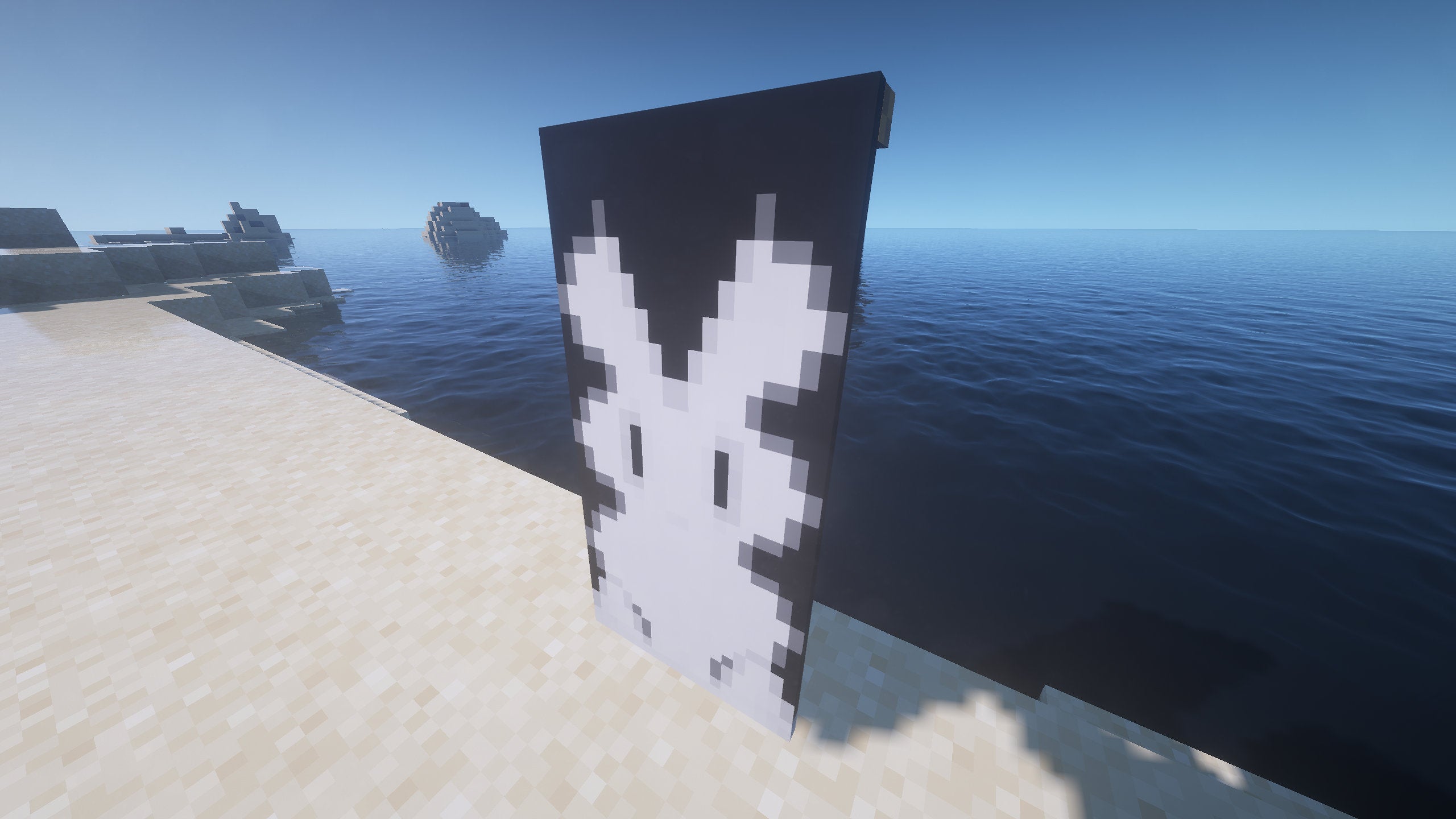 A rabbit Banner in Minecraft, placed in the ground by the coast.