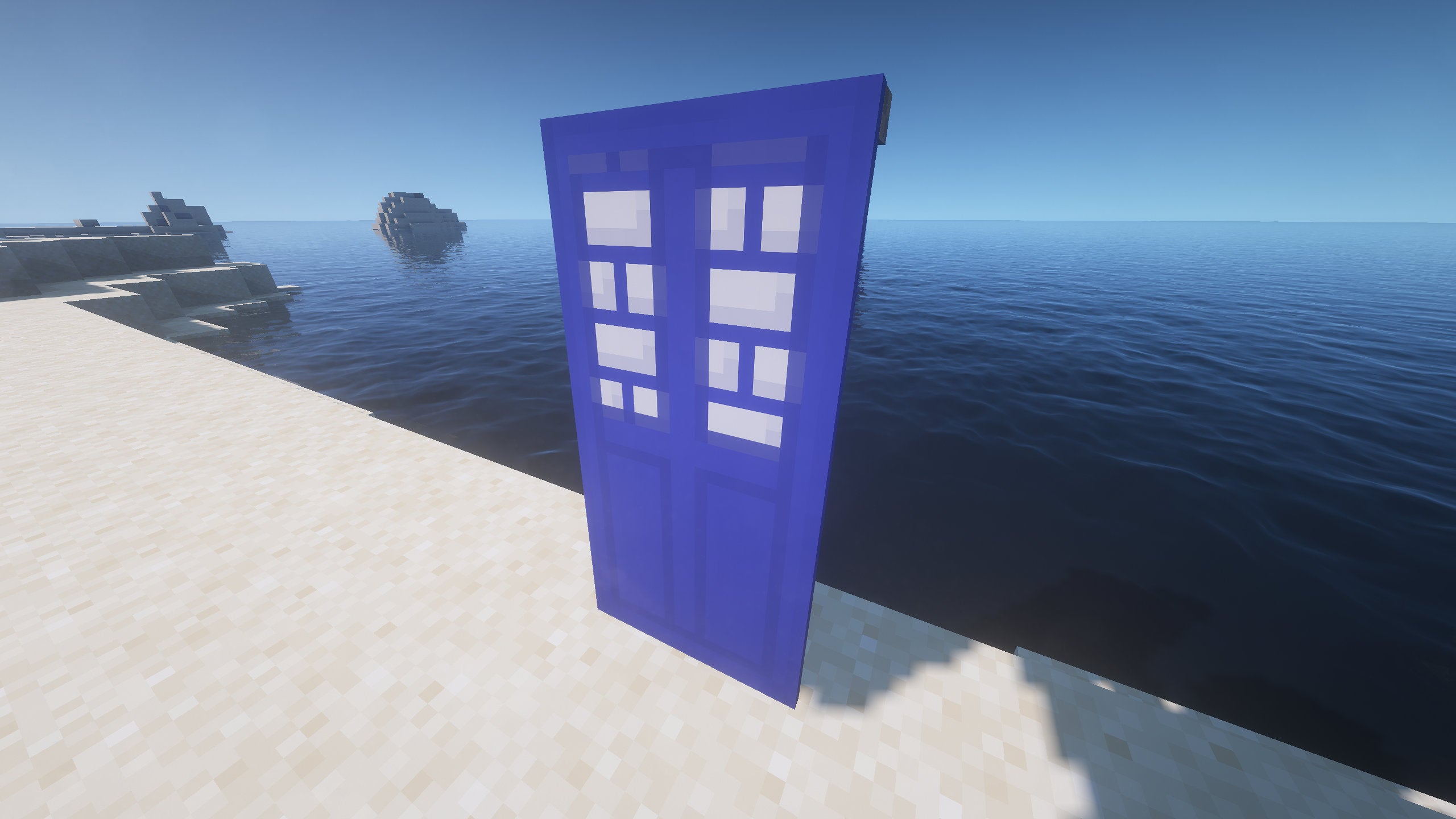 A TARDIS Banner in Minecraft, placed in the ground by the coast.
