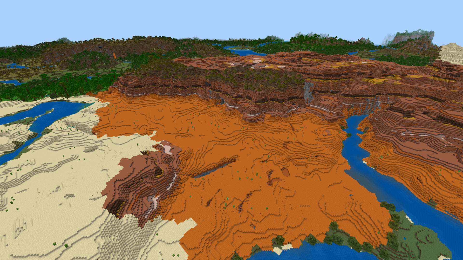 A top down view of a Badlands biome in Minecraft Bedrock, with the entrance to a ravine in the foreground below.