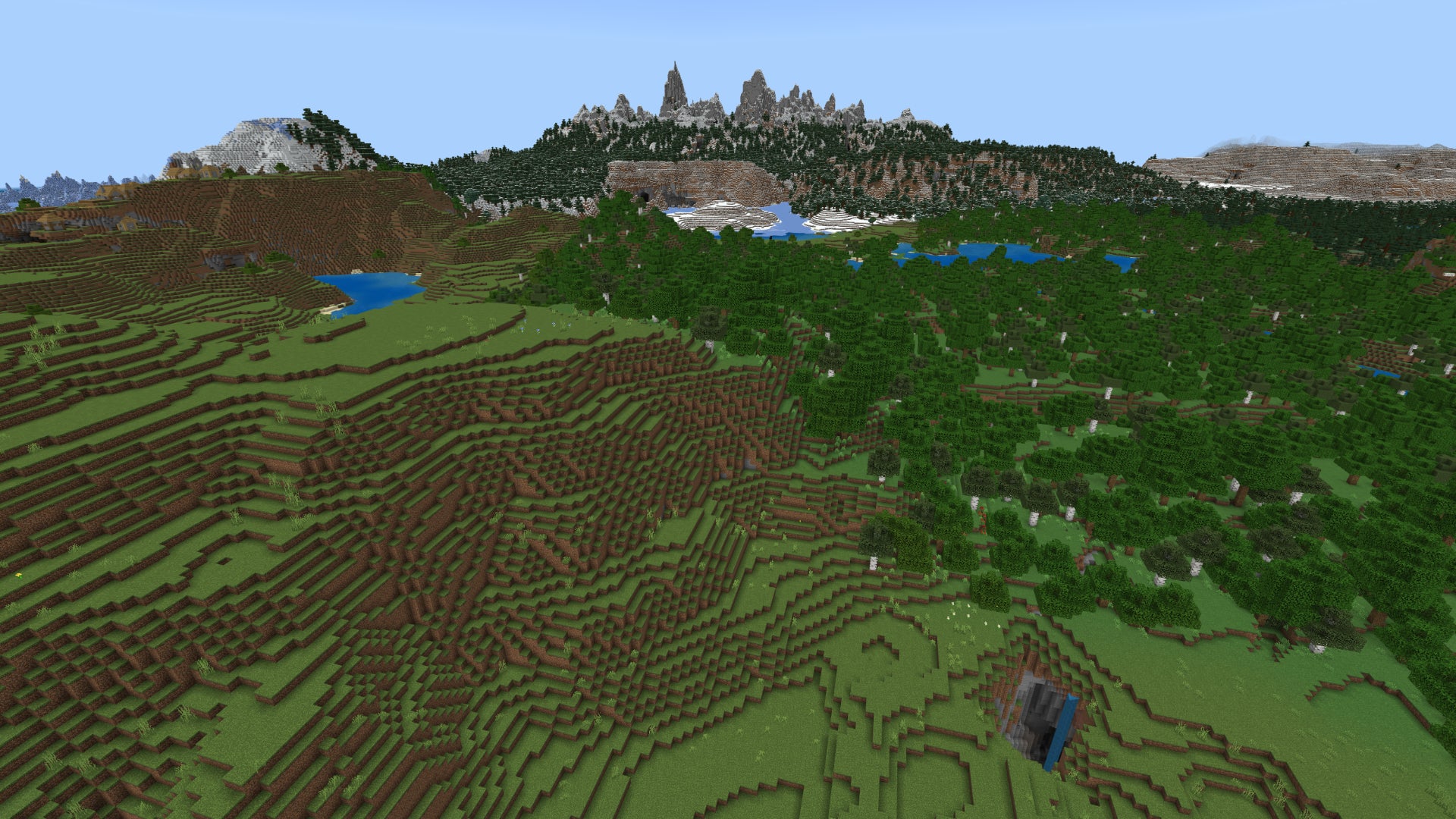 A hilly Minecraft landscape with plains on the left, forest on the right, and high snow-capped mountains in the background.