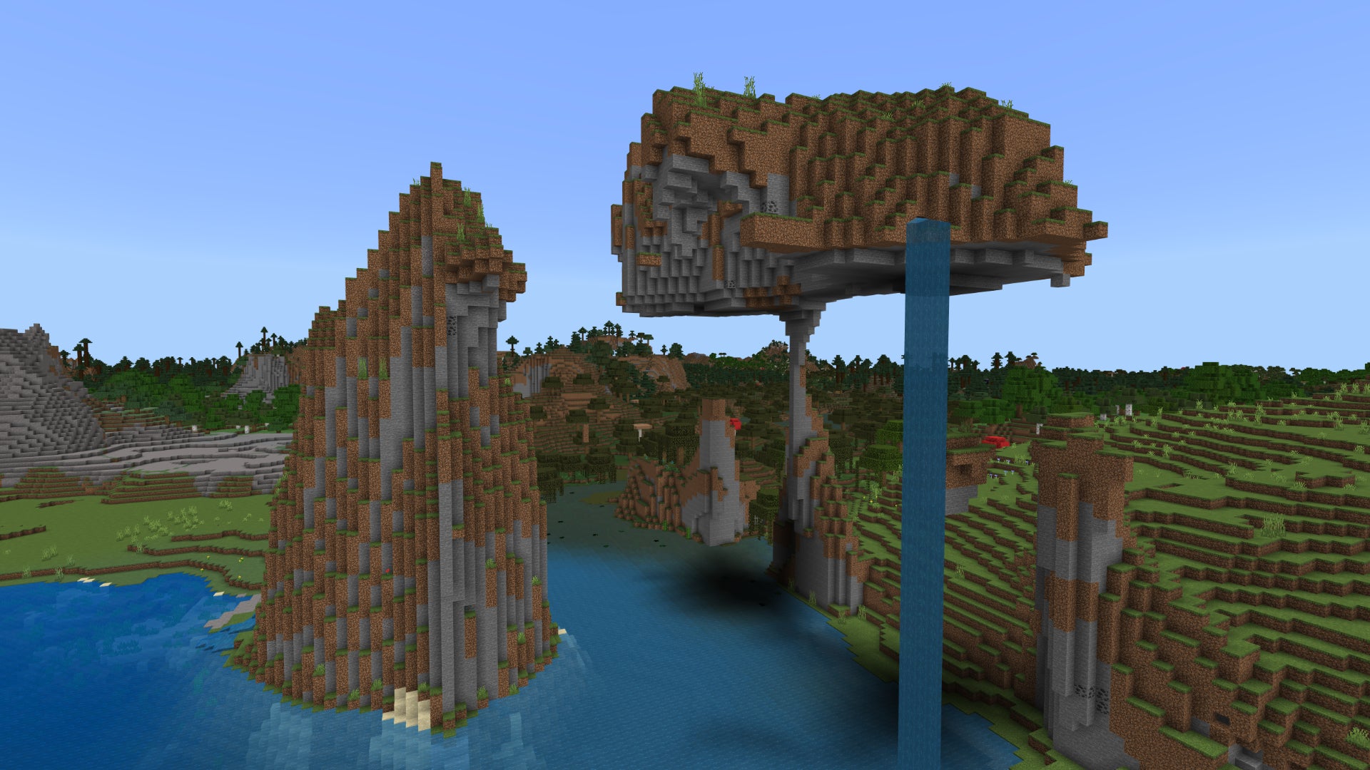 An interesting coastal rock formation in a Minecraft Bedrock world, held up by a single tiny strand of stone.