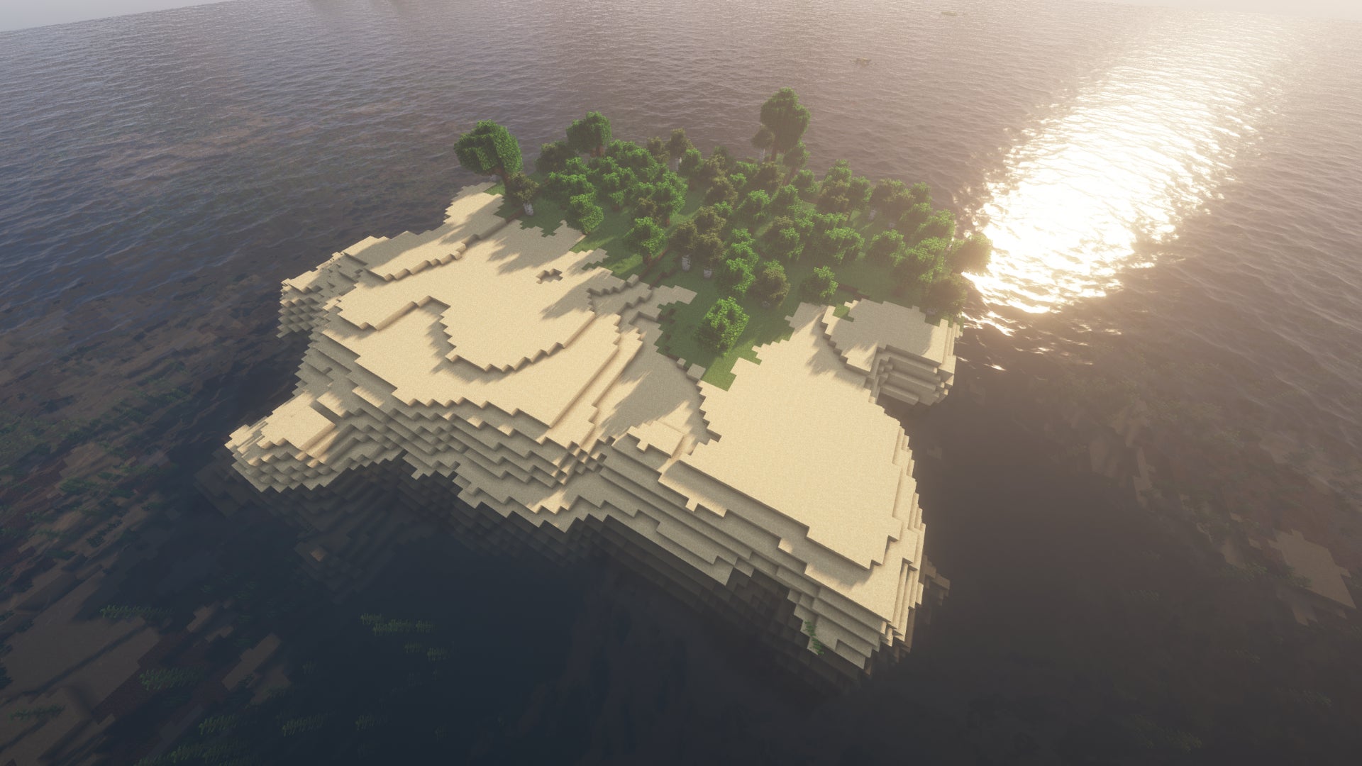 A small island surrounded by ocean in Minecraft, one side covered in sand, the other side covered in forest.
