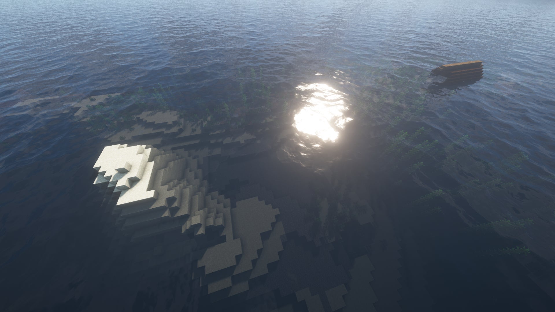 A Minecraft ocean, with a tiny sand island on the left and a shipwreck poking out of the sea on the right.