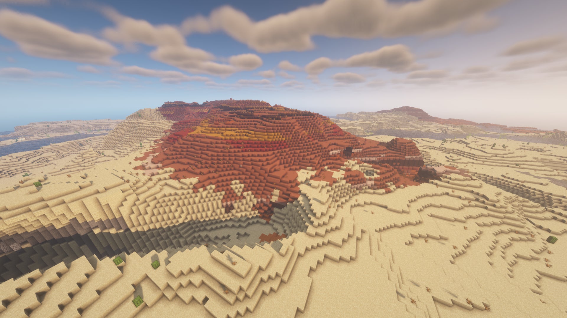 Un biome de badlands dans Minecraft, entouré de désert.