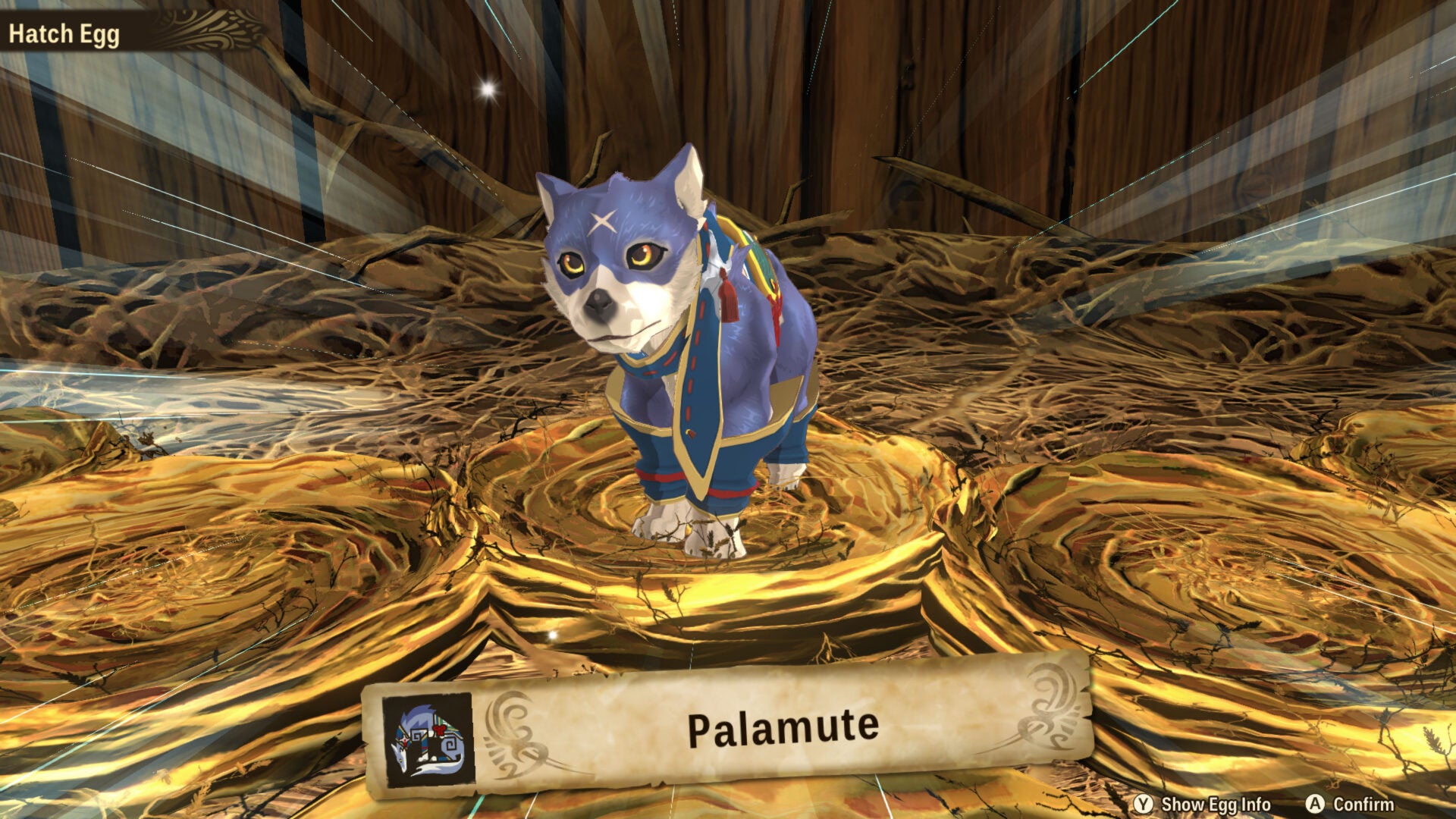 An image of a recently hatched Palamute from Monster Hunter Stories 2. It's a cute blue pup stood inside a little straw nest.