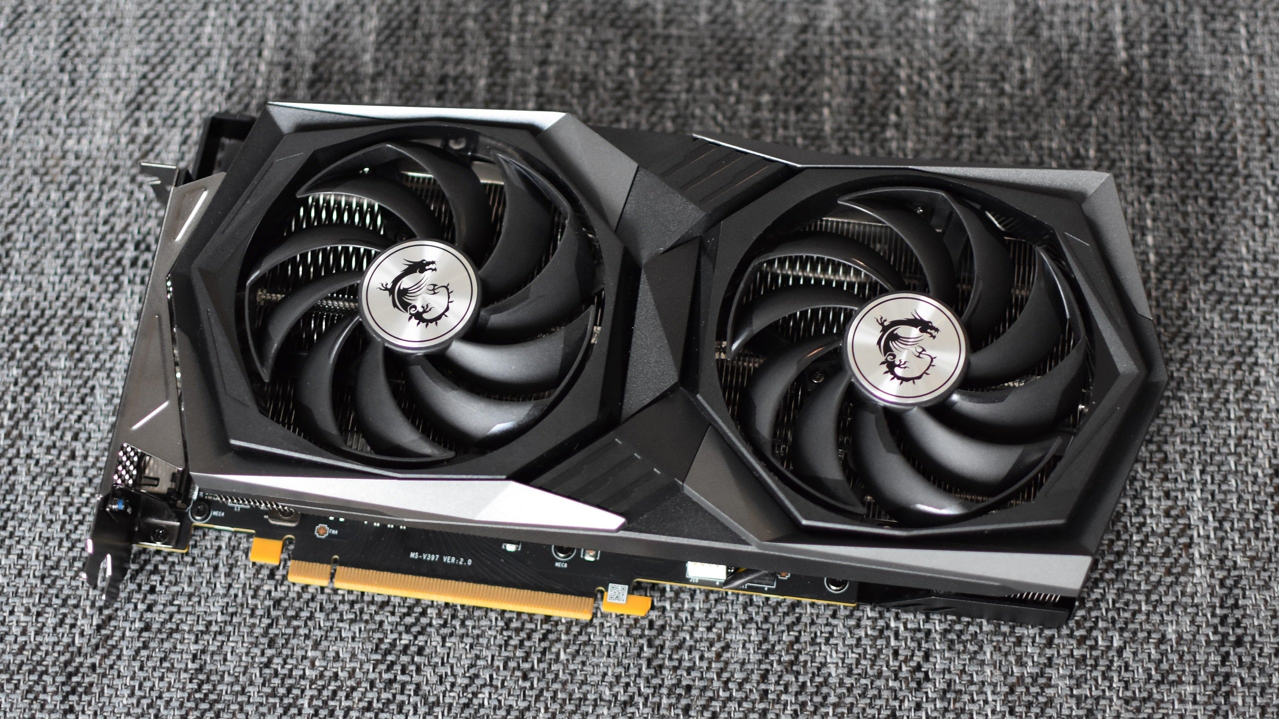 The MSI GeForce RTX 3060 Gaming X Trio graphics card, with the cooling fans facing upright.